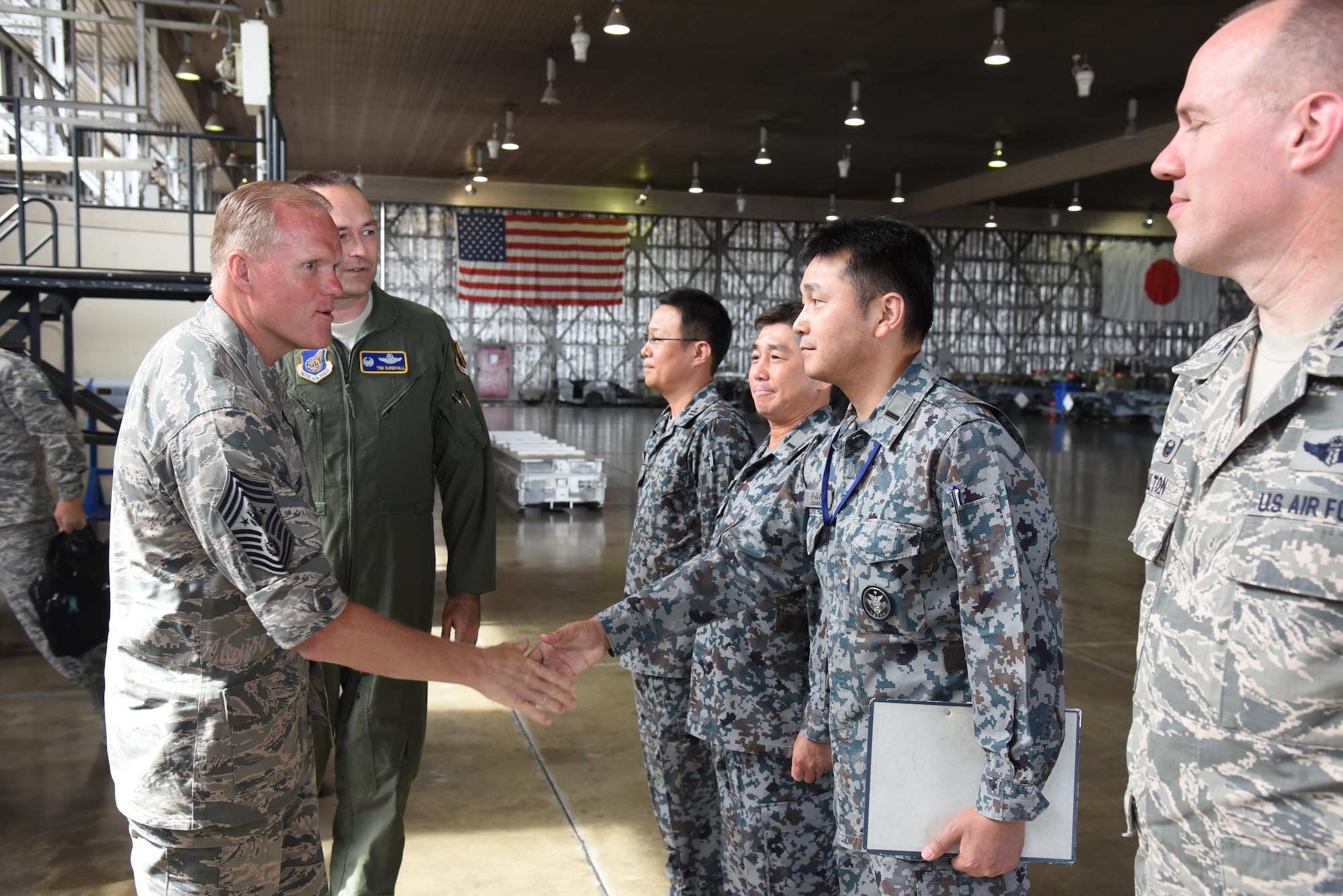Chief Master Sgt. of the Air Force James Cody meets with members from the Japan Air Self-Defense Force during a mission brief at Misawa Air Base, Japan, July 13, 2015. Cody spoke with JASDF service members and learned about their role in working with Misawa Airmen at the only bilateral, joint-service air base in the Asia-Pacific region. (U.S. Air Force photo by Senior Airman Patrick S. Ciccarone/Released)