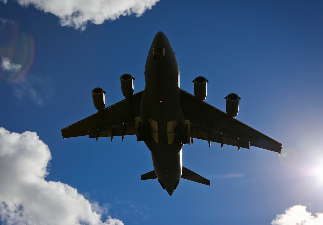 A U.S. Air Force C-17A Globemaster III transports aircraft in flight over Royal Australian Air Force Base Amberley after completing the airborne insertion to the Shoalwater Bay Training Area, Australia, July 8, 2015. (Royal Australian Air Force photo by Cpl. Shannon McCarthy/Released)