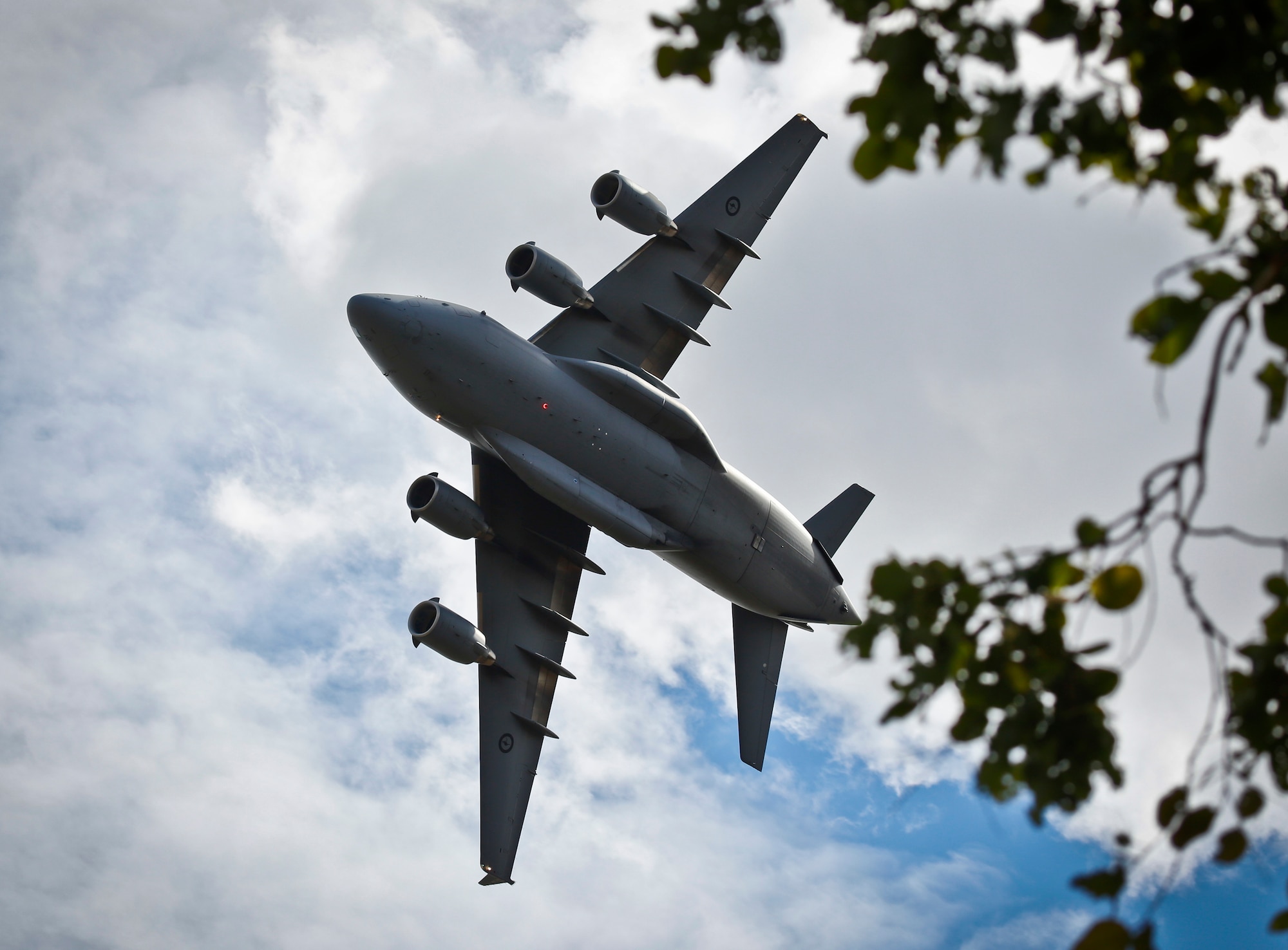 A Royal Australian Air Force No. 36 Squadron C-17A Globemaster III flies over RAAF Base Amberley after completing the airborne insertion with the U.S. Air Force and U.S. Army to the Shoalwater Bay Training Area, Australia, July 8, 2015. (Royal Australian Air Force photo by Cpl. Shannon McCarthy/Released)