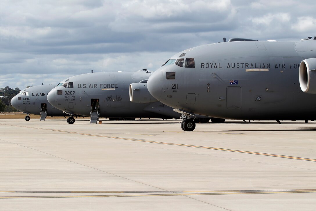 Royal Australian and U.S. Air Force C-17A Globemaster III aircraft land at RAAF Base Amberley, Australia, after an airborne insertion with the U.S. Army to the Shoalwater Bay Training Area, Australia, July 8, 2015. (Royal Australian Air Force photo by Cpl. Peter Borys/Released)
