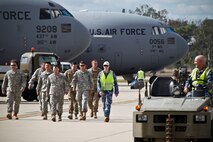 Royal Australian Air Force  personnel escort U.S. military members off the flight line at RAAF Amberley, Australia, after a personnel drop exercise during Talisman Sabre 2015, July 8, 2015. (Royal Australian Air Force photo by Cpl. Peter Borys/Released)