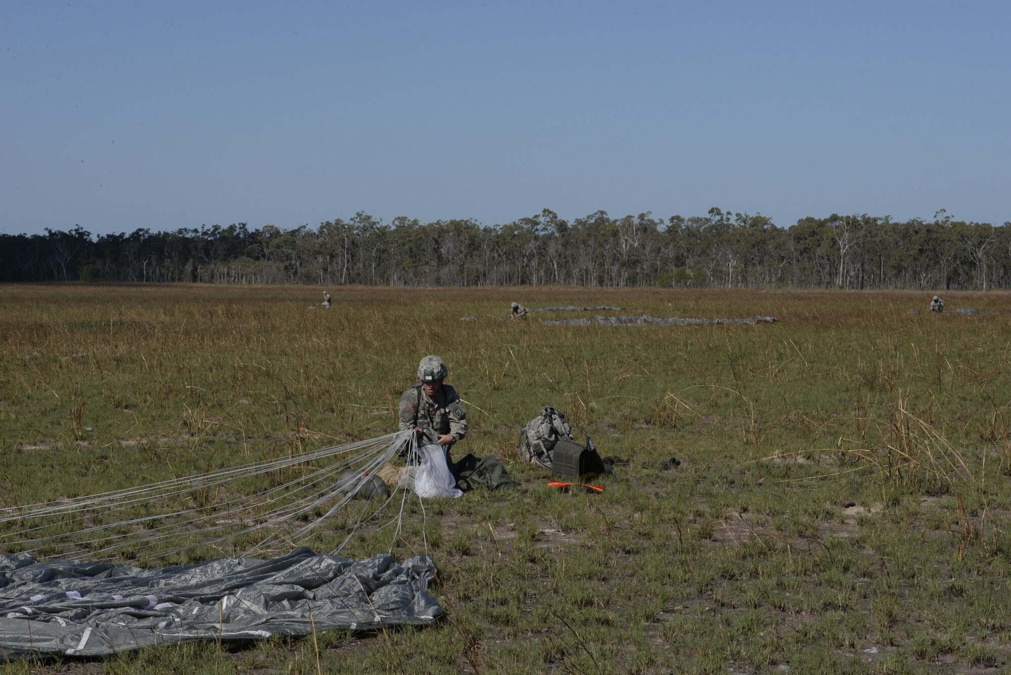 A jumper from the U.S. Army 4th Battalion, 25th Infantry Airborne packs his parachute after jumping from a C-17 Globemaster III aircraft during exercise Talisman Sabre in Northern Territory, Australia, July 8, 2015. Exercises such as Talisman Sabre 2015 provide realistic, relevant training which is necessary to maintain regional security, peace and stability. (U.S. Air Force photo by Senior Airman Stephen G. Eigel)