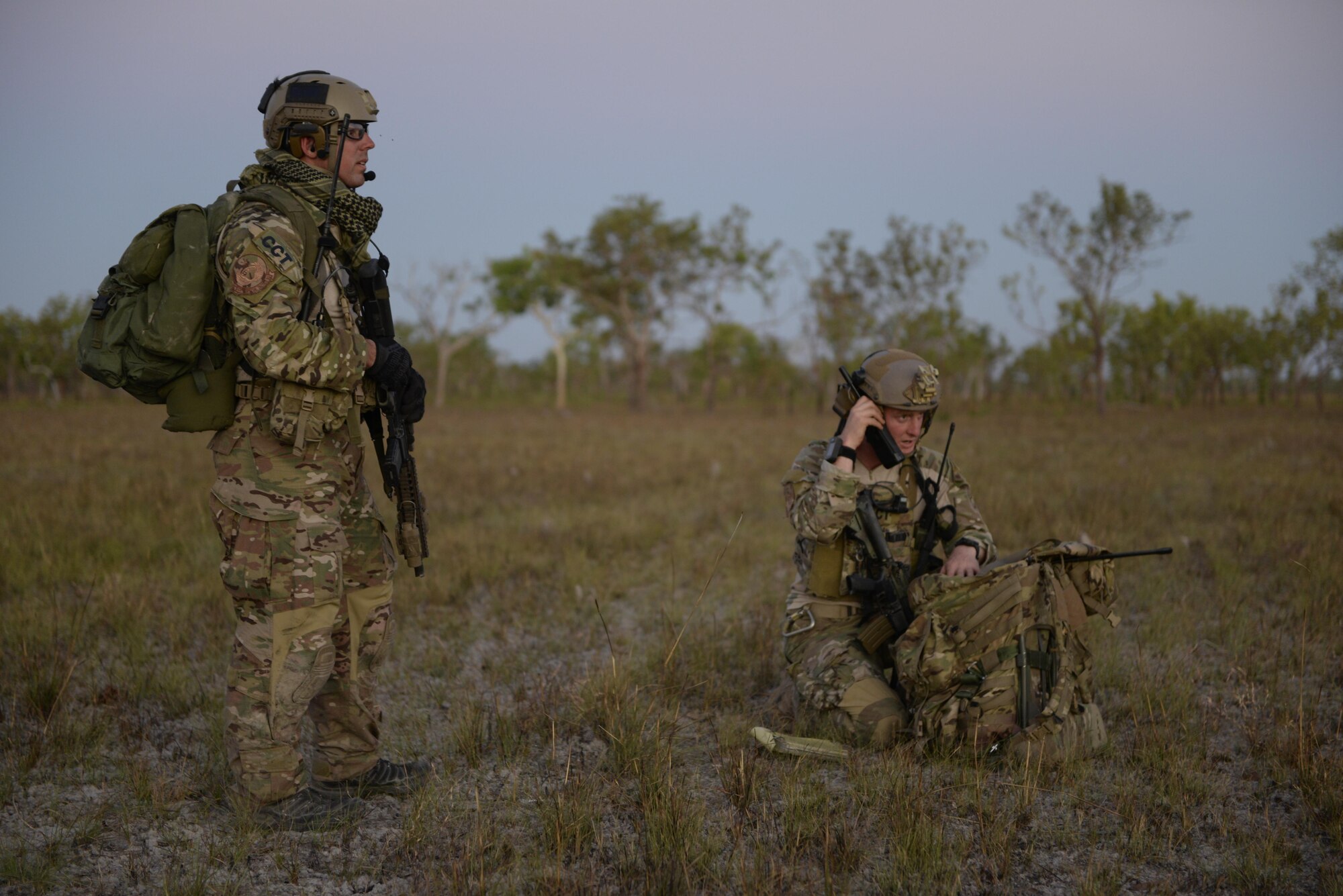 A special tactics combat controller and special tactics officer from the 320th Special Tactics Squadron get ready for a personnel recovery mission after performing a high altitude low opening jump during exercise Talisman Sabre in Northern Territory, Australia, July 10, 2015. The personnel recovery team consisted of four combat controllers, one special operations weatherman and one special tactics officer. (U.S. Air Force photo by Senior Airman Stephen G. Eigel)