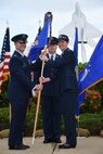 Col. Randy Huiss, 15th Wing commander, receives the 15th Medical Group guidon from Col. Virginia A. Garner, 15th MDG commander during the 15th MDG change of command ceremony on Joint Base Pearl Harbor-Hickam, Hawaii, July 14, 2015. As the 15th MDG commander Garner lead nearly 243 personnel and three squadrons, overseeing a 35 million dollar infrastructure, operations and maintenance budget. During the ceremony, Garner was presented the Legion of Merit for her outstanding service and accomplishments as commander of the 15th MDG. (U.S. Air Force Photo by Tech Sgt. Aaron Oelrich/Released)