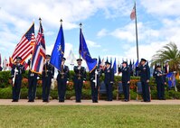 Members of the 15th Wing salute the American flag before the 15th Medical Group change of command ceremony on Joint Base Pearl Harbor-Hickam, Hawaii, July 14, 2015. Col. Christopher Paige assumed command of the 15th MDG from Col. Virginia A. Garner during the ceremony. (U.S. Air Force Photo by Tech Sgt. Aaron Oelrich/Released)