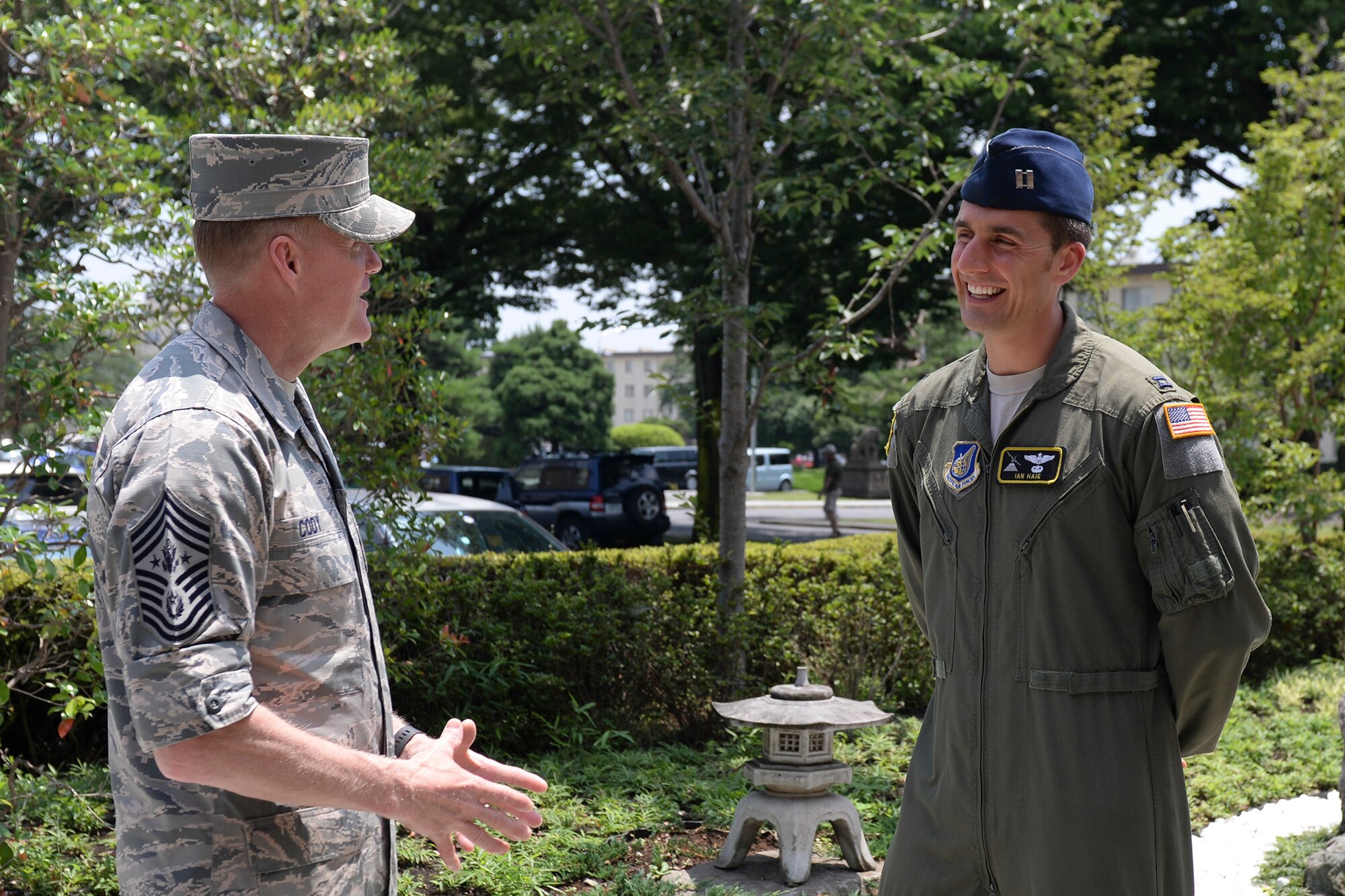 Chief Master Sgt. of the Air Force James A. Cody meets Capt. Ian Haig, 36th Airlift Squadron chief of standardization and evaluation at Yokota Air Base, Japan, July 10, 2015. Cody took time to present coins to and get to know a number of accomplished Airman during his visit to Yokota. (U.S. Air Force photo by Airman 1st Class Elizabeth Baker/Released)