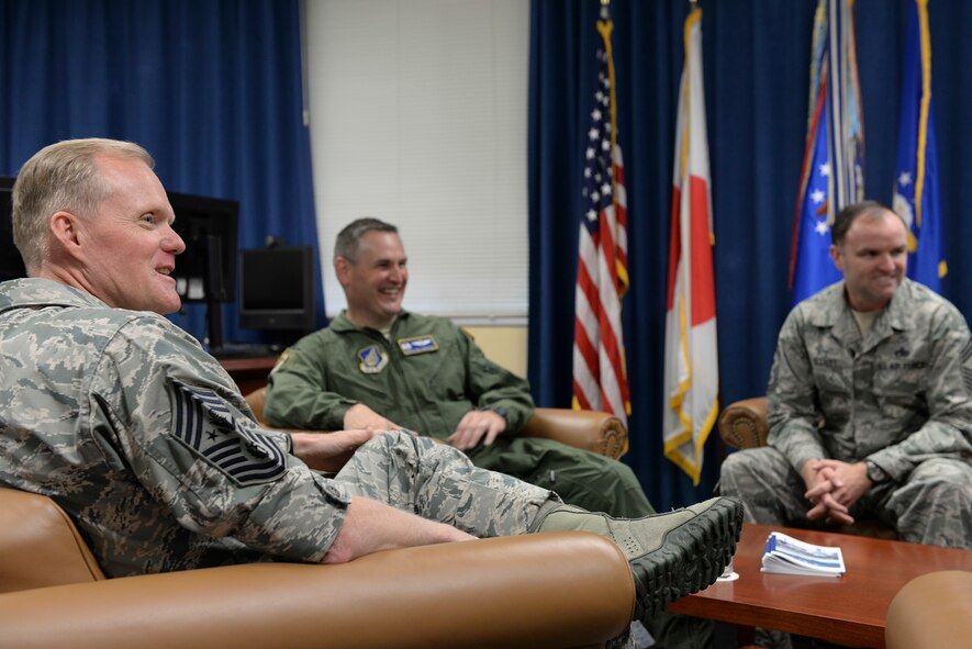 Chief Master Sgt. of the Air Force James A. Cody has a discussion with Col. Douglas DeLaMater, 374th Airlift Wing commander, and Chief Master Sgt. Paul M. Elliott, 374th Airlift Wing Chief command chief, at Yokota Air Base, Japan, July 10, 2015. Cody discussed a variety of topics that concern enlisted Airmen during his tour of Yokota Air Base. (U.S. Air Force photo by Airman 1st Class Elizabeth Baker/Released)