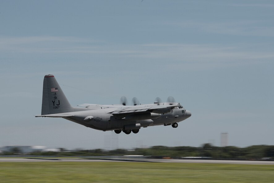 A C-130 Hercules takes off during large formation training at Yokota Air Force Base, Japan, July 14, 2015. Nine C-130 Hercules took off during the training, practicing their airlift capabilities and highlighting Yokota's role as the primary airlift hub in the Indo-Asia Pacific Region. (U.S. Air Force photo by Staff Sgt. Cody H. Ramirez/Released)