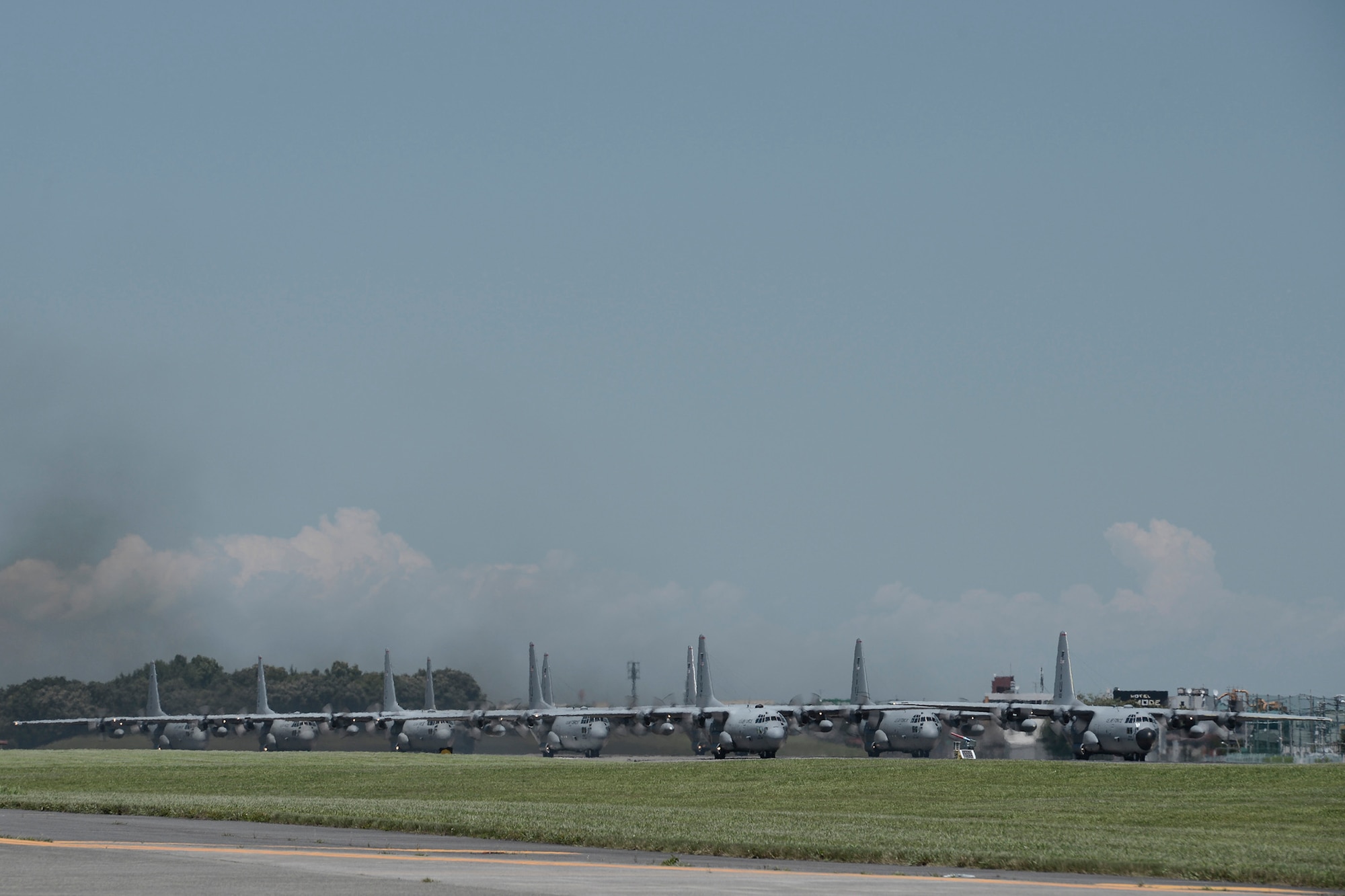 Nine C-130 Hercules prepare to take off during large formation training at Yokota Air Base, Japan, July 14, 2015. The C-130s practiced their large formation and airlift capabilities. (U.S. Air Force photo by Staff Sgt. Cody H. Ramirez/Released)
