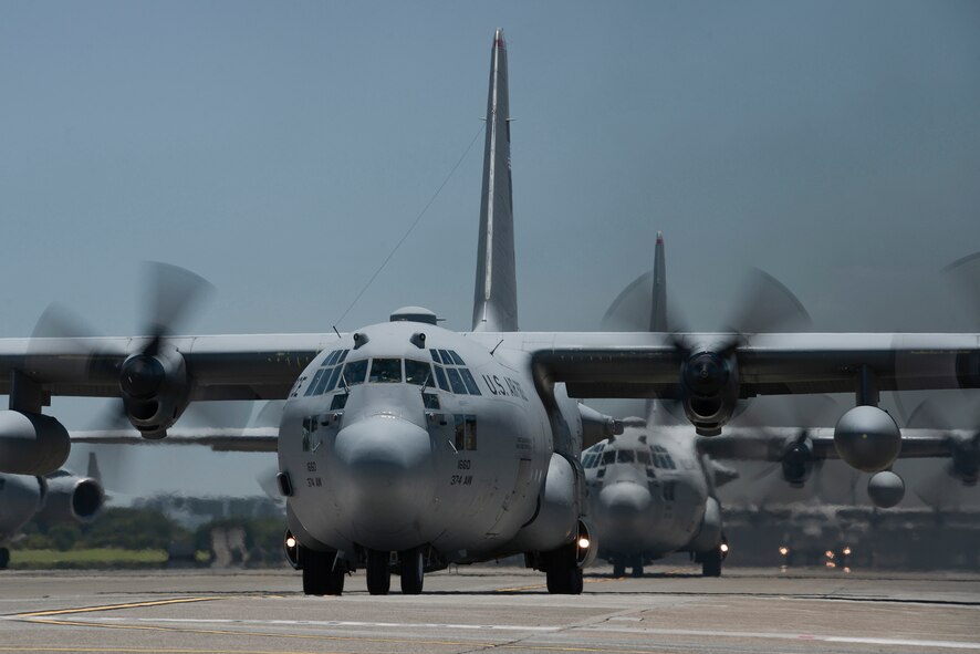 Multiple C-130 Hercules with the 374th Airlift Wing taxi during large formation training at Yokota Air Base, Japan, July 14, 2015. The training allowed aircrews an opportunity to practice their large formation and airlift capabilities. (U.S. Air Force photo by Staff Sgt. Cody H. Ramirez/Released)