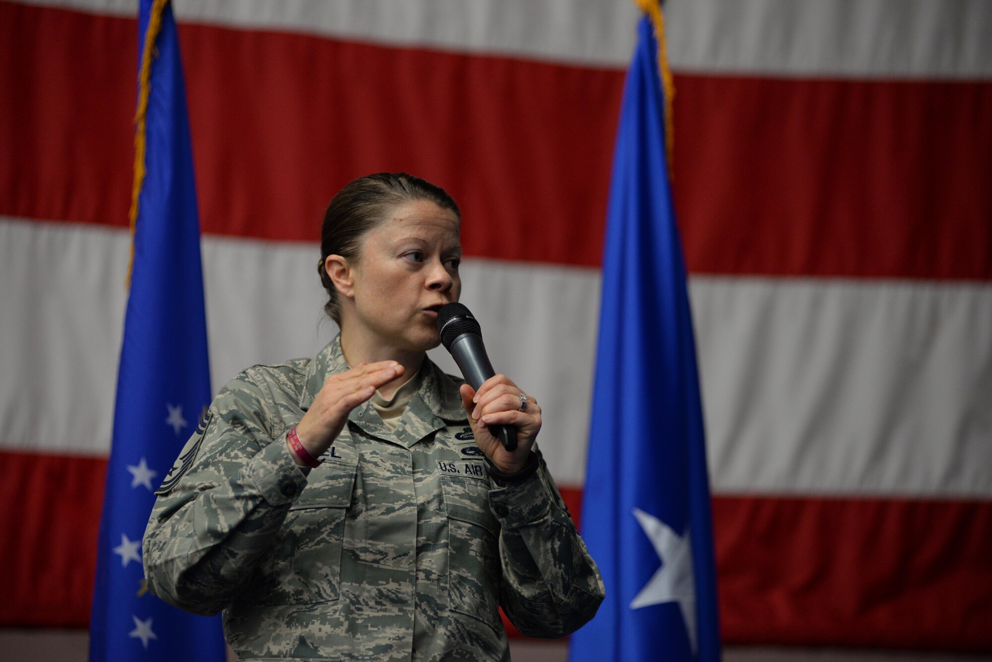 Chief Master Sgt. Brandy Petzel, Headquarters Air Force chief of enlisted force policy, presents the new enlisted evaluation system July 13, 2015, at Andersen Air Force Base, Guam. Airmen attended an all-call with Air Force Personnel Center officials to learn more about fundamental changes to the enlisted evaluation system and Weighted Airmen Promotion System. (U.S. Air Force photo by Senior Airman Alexander W. Riedel/Released)