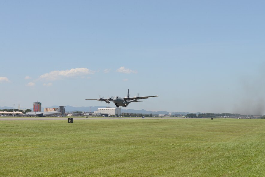 A C-130 Hercules takes to the sky as part of large formation training at Yokota Air Base, Japan, July 14, 2015. Nine C-130s took off as part of a surge mission highlighting Yokota’s role as the primary airlift hub for the Indo-Asia Pacific Region. (U.S. Air Force photo by Airman 1st Class David C. Danford/Released)