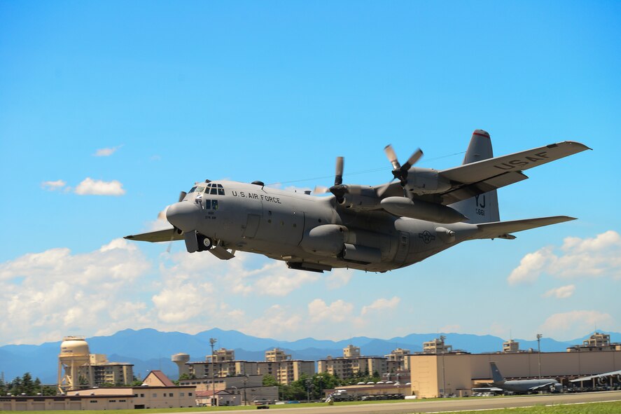 A C-130 Hercules takes off during a training exercise at Yokota Air Base, Japan, July 14, 2015. Ten C-130s participated in the exercise which tested the 36th Airlift Squadron’s ability to perform large formation flights. (U.S. Air Force photo by Senior Airman David Owsianka/Released)