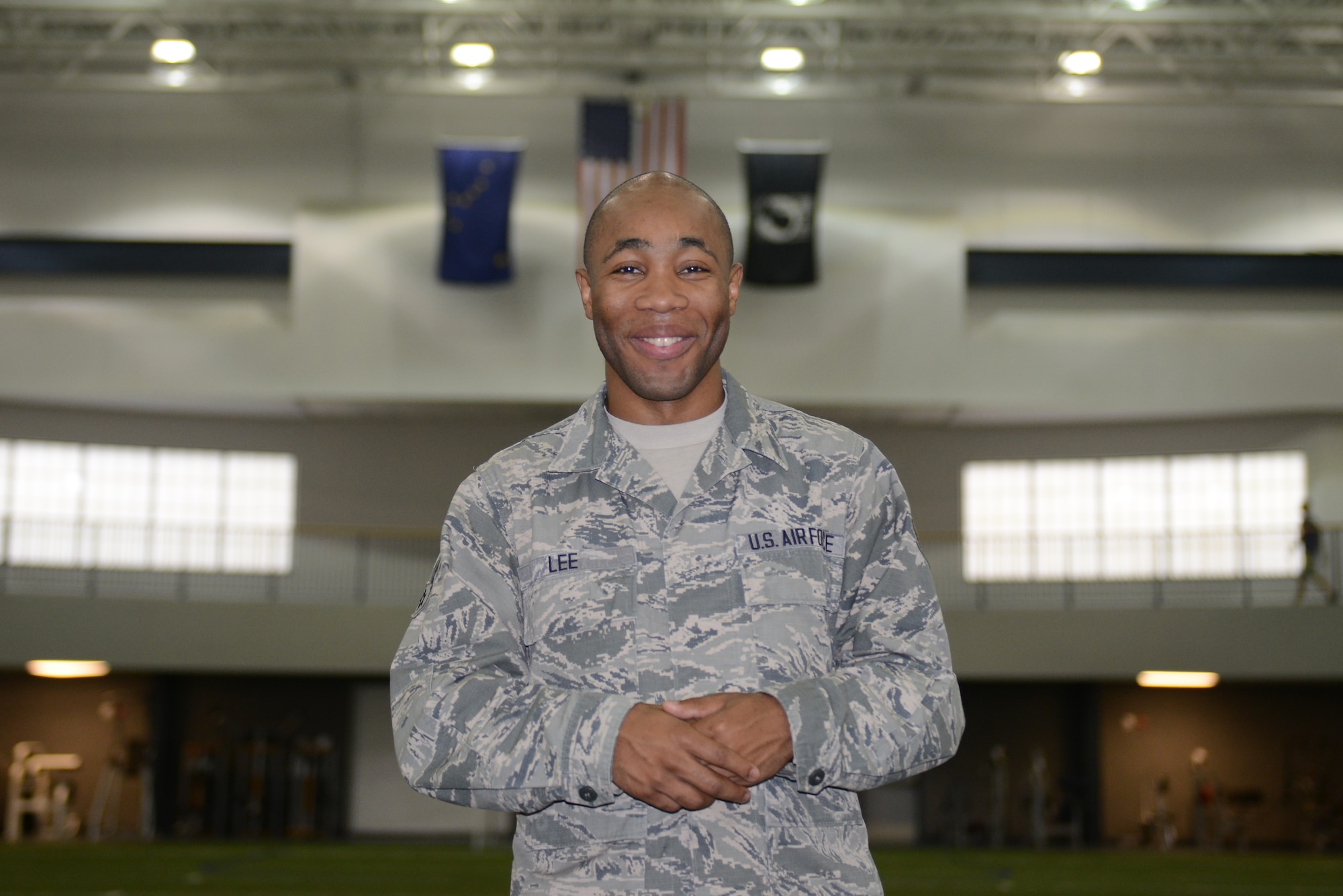 U.S. Air Force Airman 1st Class Lazrus Lee, a 354th Force Support Squadron fitness specialist, smiles during his work day, July 13, 2015, in the Baker Field House, at Eielson Air Force Base, Alaska. Lee said serving in the Air Force is important to him because it gives him an opportunity to look out for both his family and country. (U.S. Air Force photo by Senior Airman Ashley Nicole Taylor/Released)