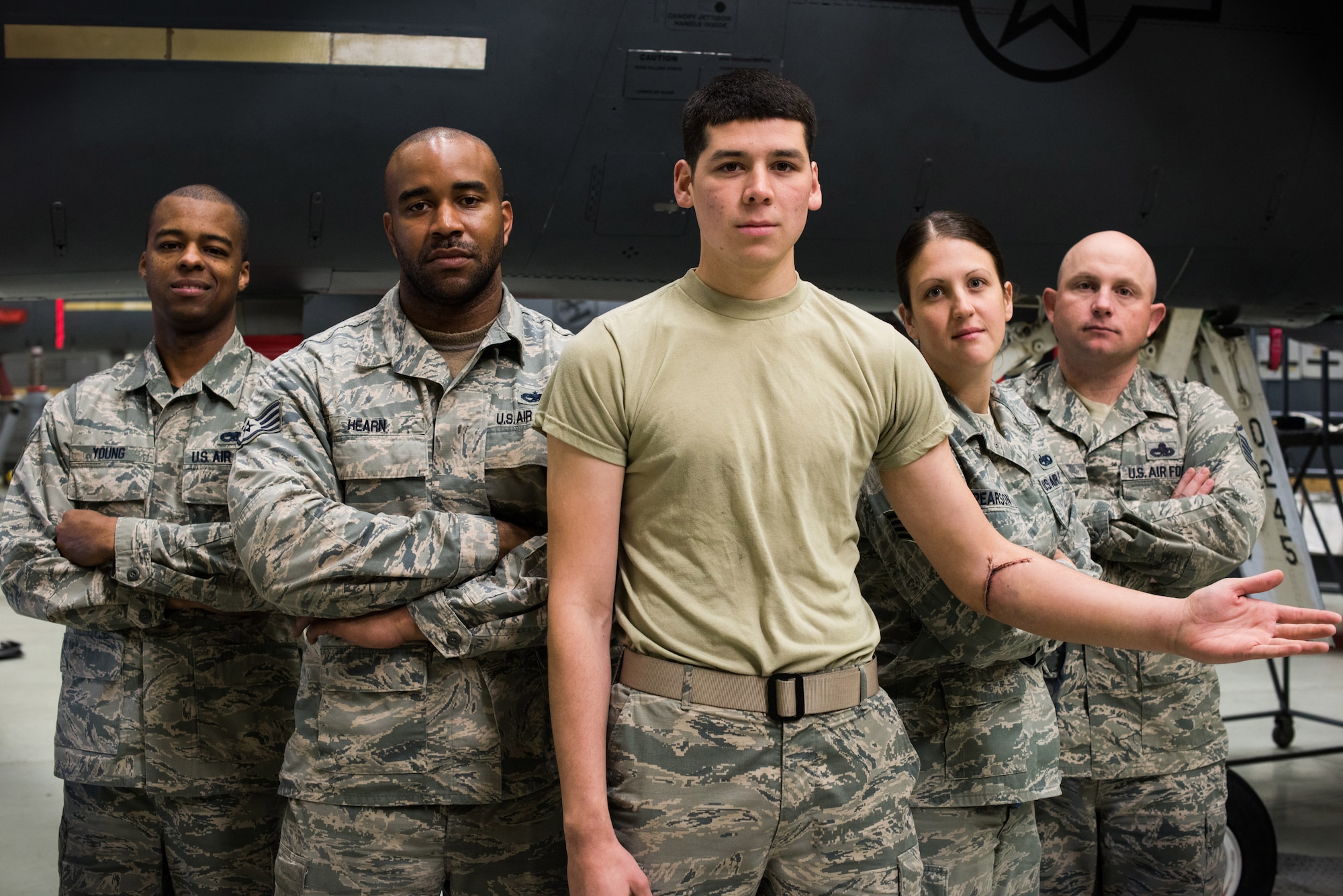 Airmen from the 366th Equipment Maintenance Squadron pose for a photo at Mountain Home Air Force Base, Idaho May 14, 2015. On April 2, Airman 1st Class Saul Vasquez (Center) tore his radial artery inside the belly of an F-15E Strike Eagle. Without the quick response and first aid training of squadron personnel, he may not be alive today. (U.S. Air Force photo by Airman Connor J. Marth)