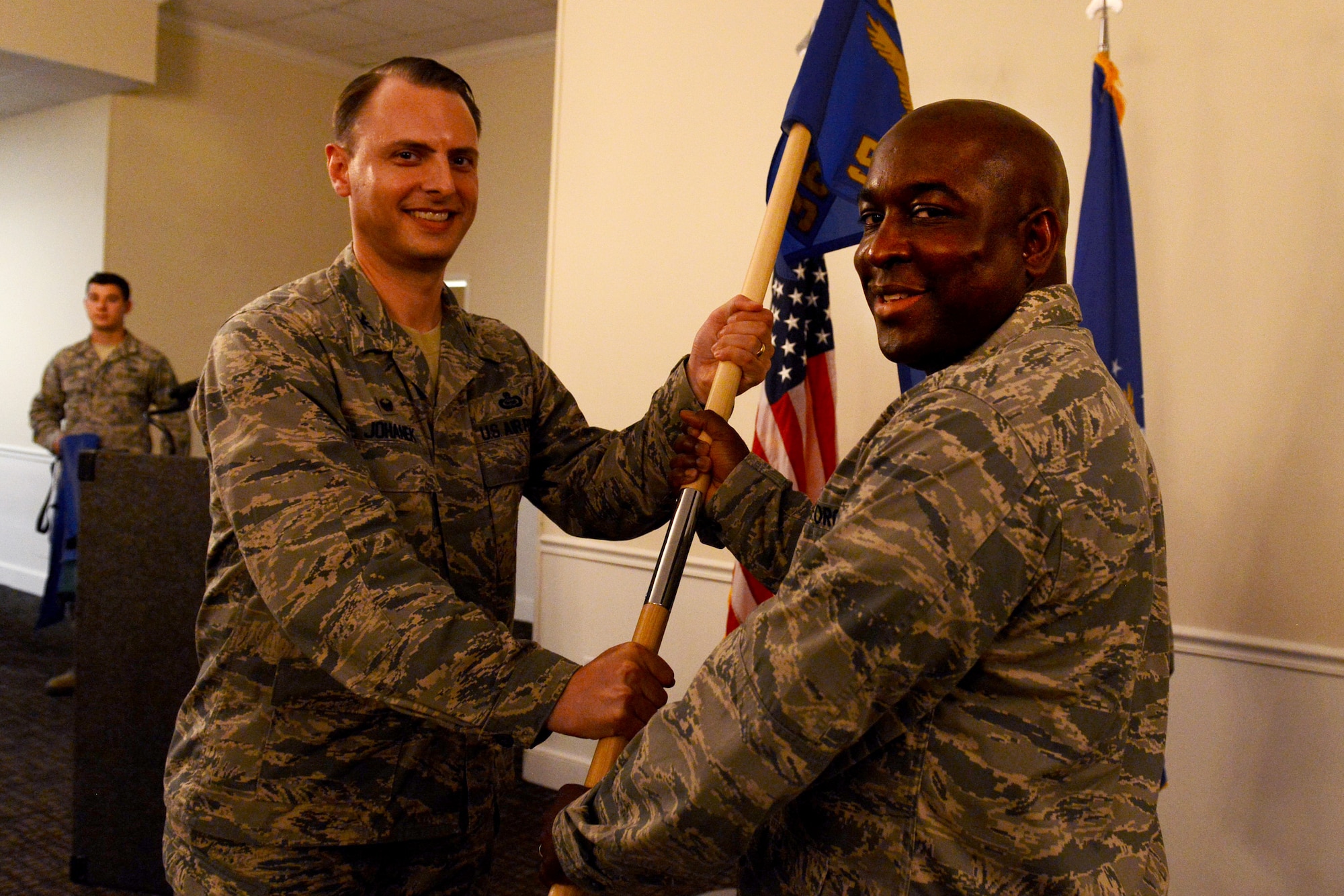 U.S. Air Force Lt. Col. Ryan O’Neal, incoming 51st Intelligence Squadron commander, is handed the guideon from Col. Michael Johanek, 365th Intelligence, Surveillance and Reconnaissance Group commander, during an assumption of command ceremony at Shaw Air Force Base, S.C., July 10, 2015. The 51st IS, previously named the 21st Reconnaissance Technical Squadron, was re-activated Feb. 17, 2015 after being inactive for 31 years. (U.S. Air Force photo by Senior Airman Diana M. Cossaboom/Released)