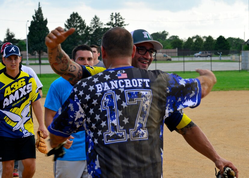 Kenneth Bancroft, 436th Security Forces Squadron, and Edward Laurie, 436th Aircraft Maintenance Squadron, both player-coaches, hug each other after an intramural softball game July 6, 2015, at the softball field on Dover Air Force Base, Del. The matchup between the two teams is considered to be one of the most highly anticipated games of the season. (U.S. Air Force photo/Airman 1st Class William Johnson)