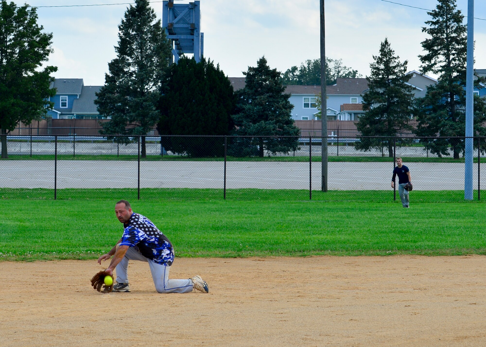 Kenneth Bancroft, 436th Security Forces Squadron player-coach, fields a ground ball during an intramural softball game against the 436th Aircraft Maintenance Squadron July 6, 2015, at Dover Air Force Base, Del. The 436th SFS are the defending intramural softball champions and are struggling to guard their title during the regular season with a record of 1-6. (U.S. Air Force photo/Airman 1st Class William Johnson)