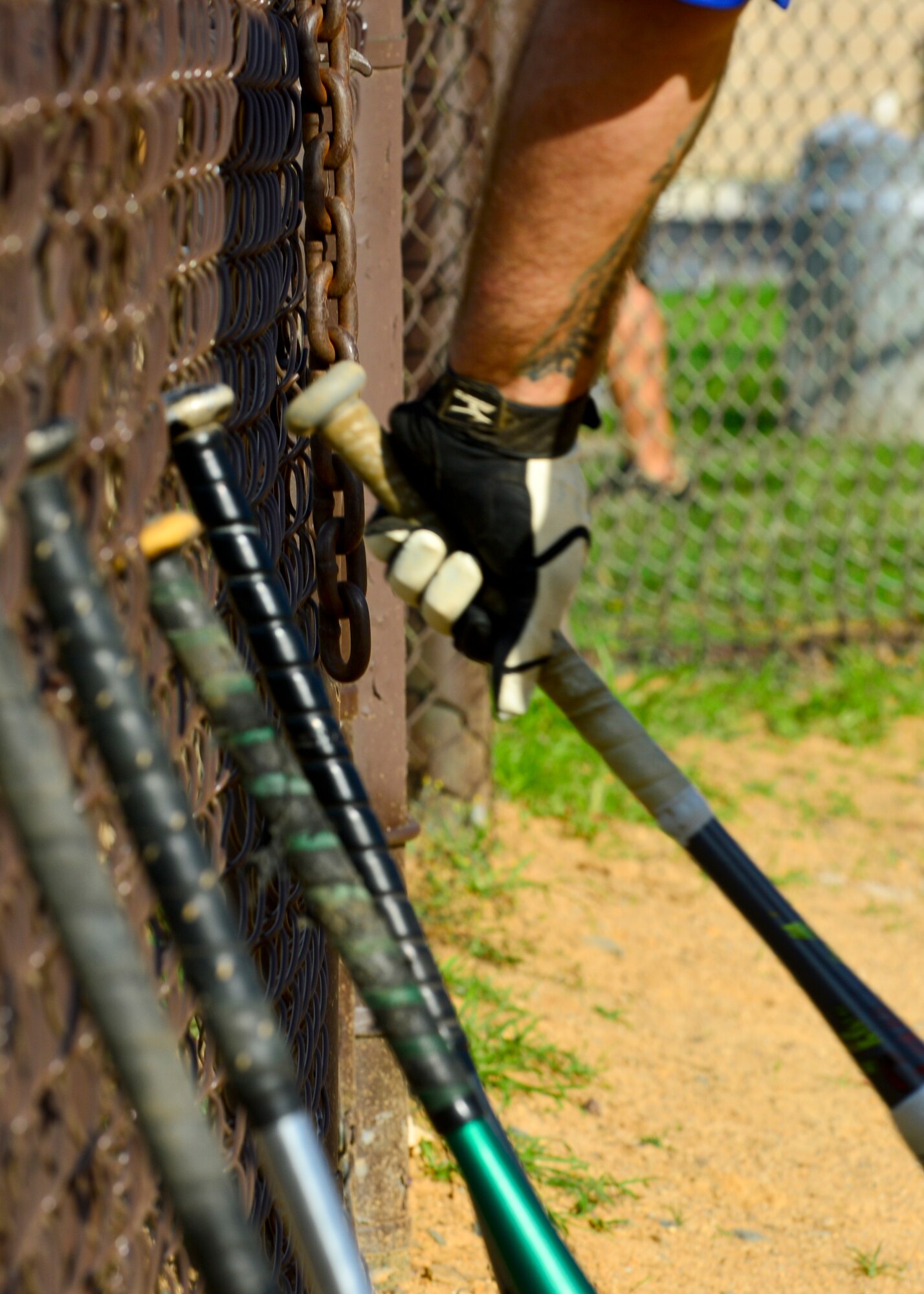 Kenneth Bancroft, 436th Security Forces Squadron player-coach, grabs a bat on his way to the batter’s box during an intramural softball game July 6, 2015, at the softball field on Dover Air Force Base, Del. The 436th SFS were defeated by the 436th Aircraft Maintenance Squadron 18-12. (U.S. Air Force photo/Airman 1st Class William Johnson)