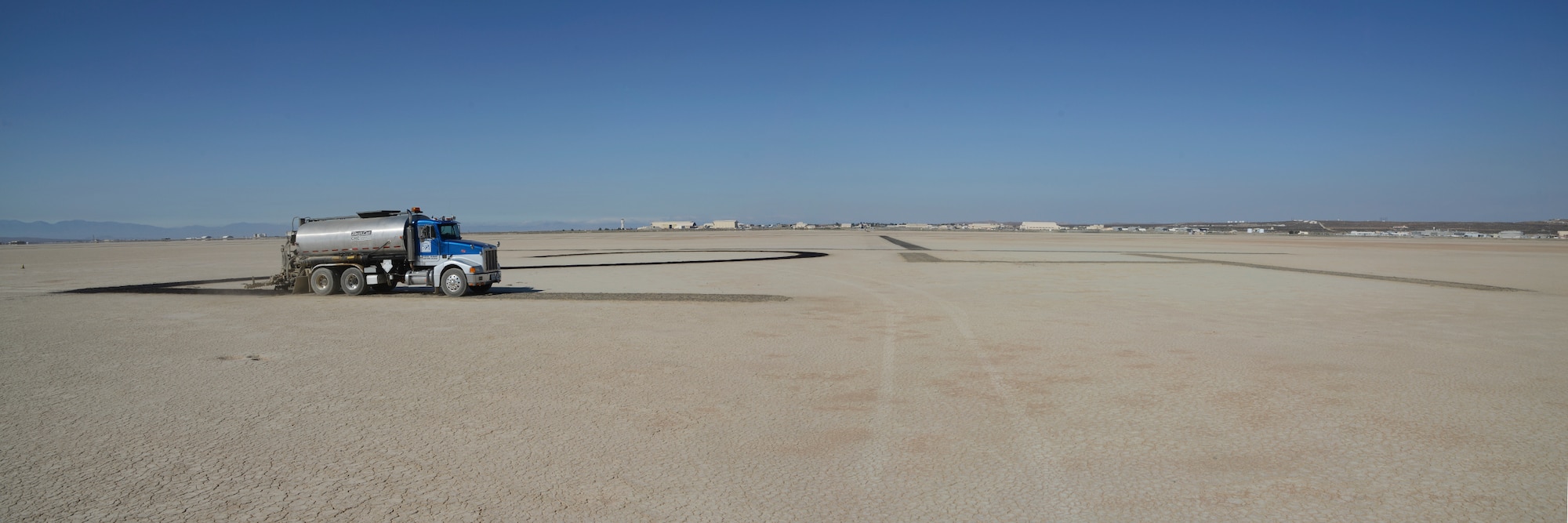 The 412th Civil Engineering Group, 412th Operations Support Squadron and contract company EM Oil, began the annual lakebed restriping July 7. Runway 06/24 receives a fresh coat of oil ensuring the visibility of runway designator “24.” (U.S. Air Force photo by Rebecca Amber)