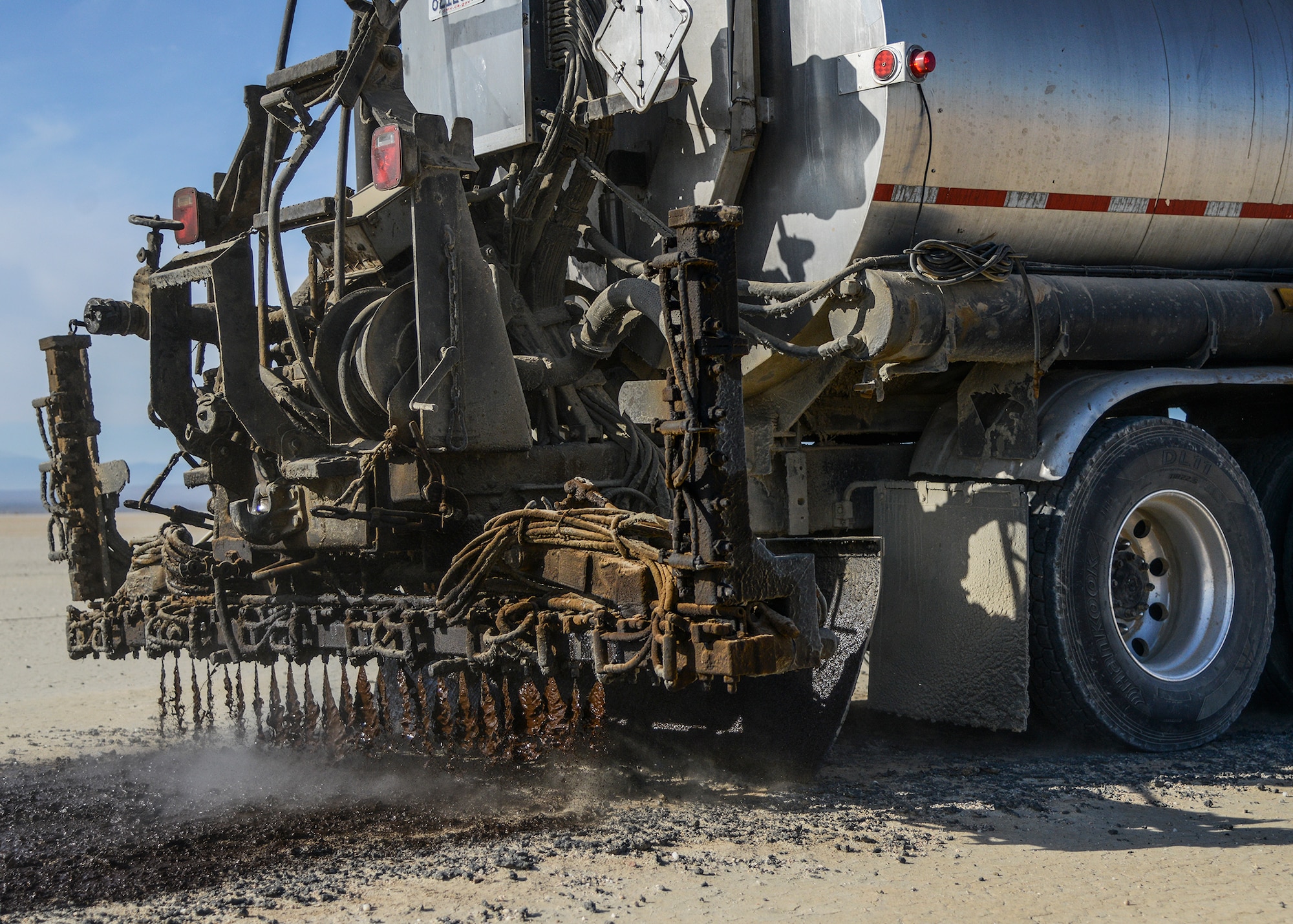 Environmentally friendly oil, SSH1 is used to restripe lakebed runways each year at Edwards AFB. The biodegradable oil is a water soluble mixture of 60 percent oil and 40 percent water. (U.S. Air Force photo by Rebecca Amber)