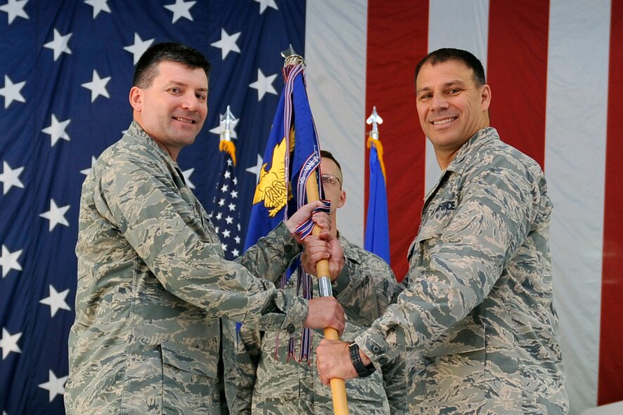 U.S. Air Force Col. Matthew Joganich takes the 55th Mission Support Group guidon from U.S. Air Force Col. Marty Reynolds, 55th Wing commander, during a change of command ceremony July 14, 2015. Joganich took command of the 55th MSG from U.S. Air Force Col. Charles Kuhl. (Photo by Jeff Gates)