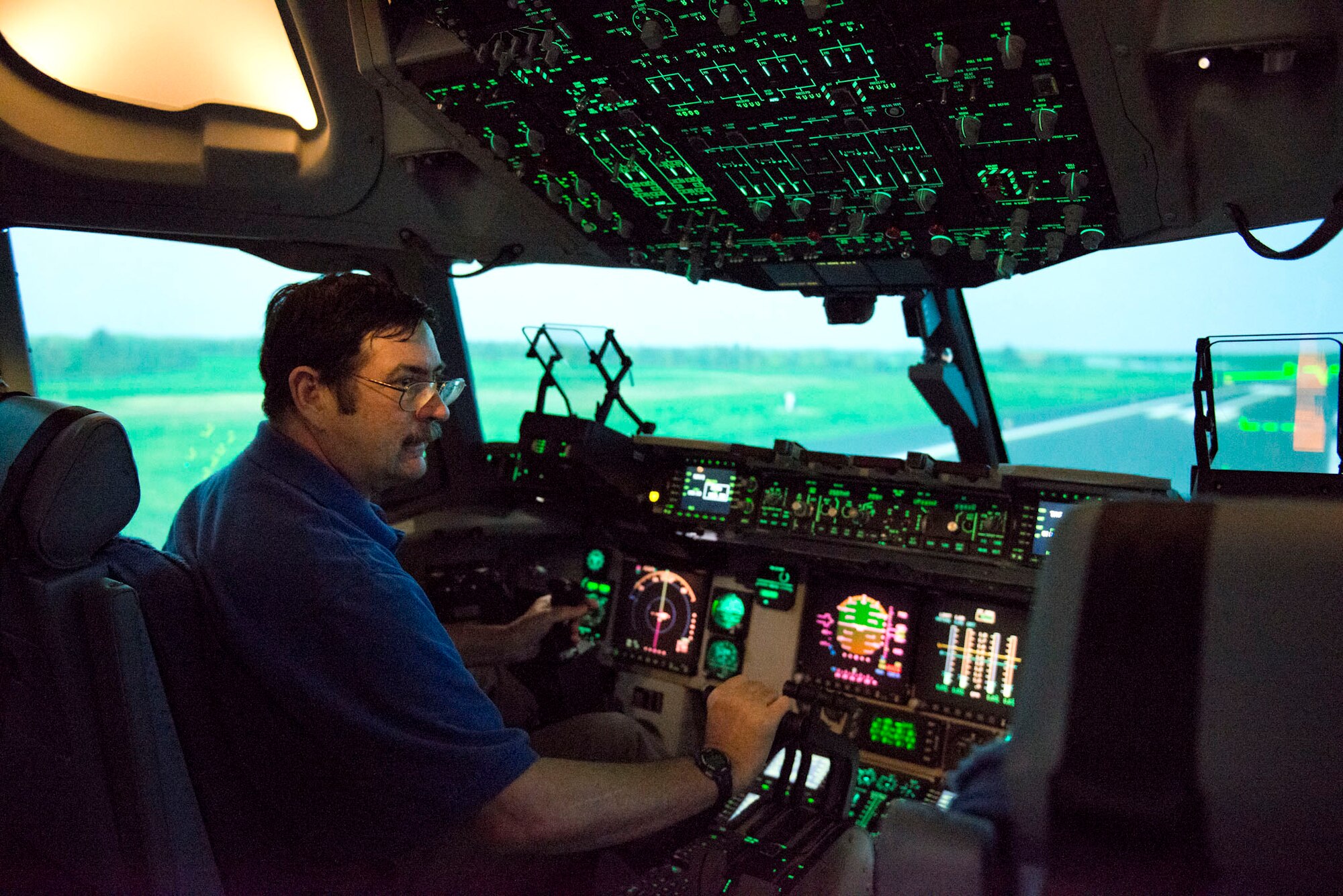 Paul Whidden, a simulator maintenance technician III with True Simulation in Martinsburg, W.Va., takes a ride in the new C-17 simulator at the 167th Airlift Wing, Martinsburg, W.Va. The simulator is used by pilots and loadmasters to practice their skills in a very life-like simulator. The simulator will have the capability in the future to link up with other airframes from other units and go through different flying scenarios. (Air National Guard photo by Staff Sgt. Jodie Witmer/released)