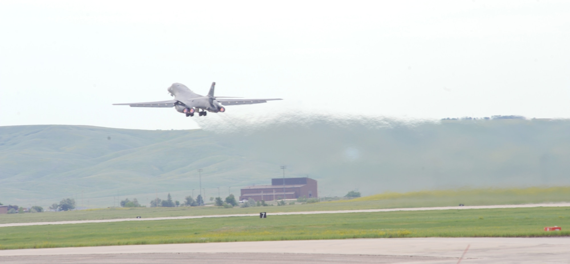 A B-1 bomber from the 34th Bomb Squadron takes off in route to Tinker Air Force Base, Okla., for an Integrated Battle Station systems upgrade at Ellsworth Air Force Base, S.D., June 30, 2015.The IBS systems upgrade schedule currently allows Ellsworth to send one aircraft at a time to receive improvements to analog cockpit displays which will link the B-1b to a global communications network.  (U.S. Air Force photo by Airman Sadie Colbert/Released)