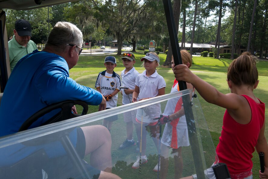 Roger Marcellus, 23d Force Support Squadron supervisory recreation specialist, speaks to participants during the Quiet Pines Summer Golf League July 9, 2015, at Moody Air Force, Ga. Throughout the course, the children learned the basics of golf, how to swing a golf club and different hitting techniques. (U.S. Air Force photo by Airman 1st Class Kathleen D. Bryant/Released)

