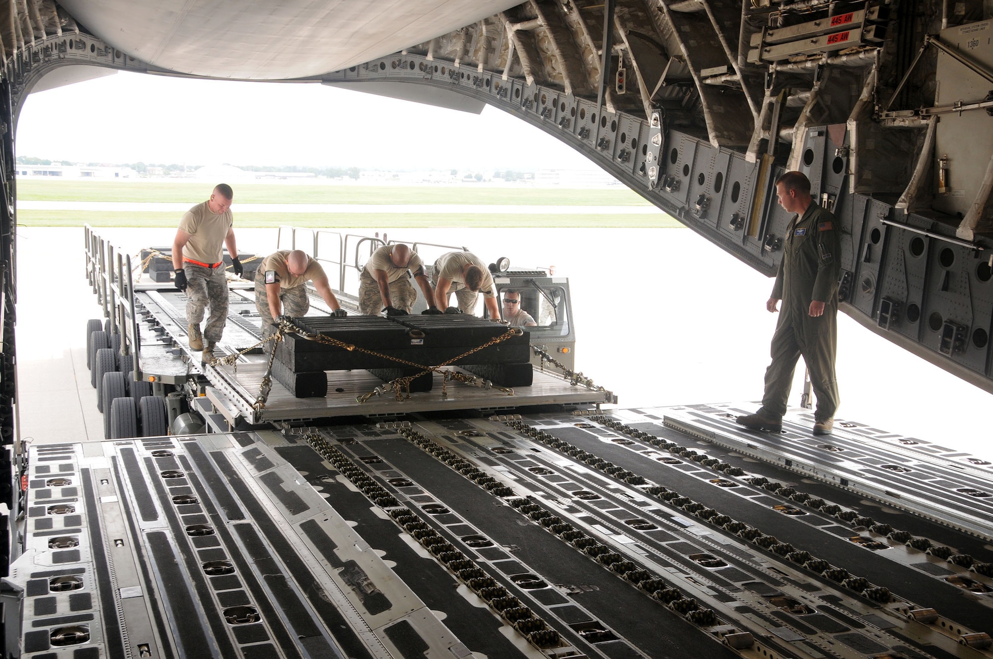 WRIGHT-PATTERSON AIR FORCE BASE, Ohio – Airmen from the 87th Aerial Port Squadron load cargo on the back of a C-17 Globemaster III July 11, 2015 to show their squadron’s capabilities to Marine Corps Sgt. Maj. Bryan B. Battaglia, the senior enlisted advisor to the chairman of the Joint Chiefs of Staff, during his visit to the 445th Airlift Wing. During his visit here, Battaglia toured the aircraft and participated in demonstrations by the 445th Aeromedical Evacuation and Aeromedical Staging Squadrons. (U.S. Air Force photo/Tech. Sgt. Anthony Springer)