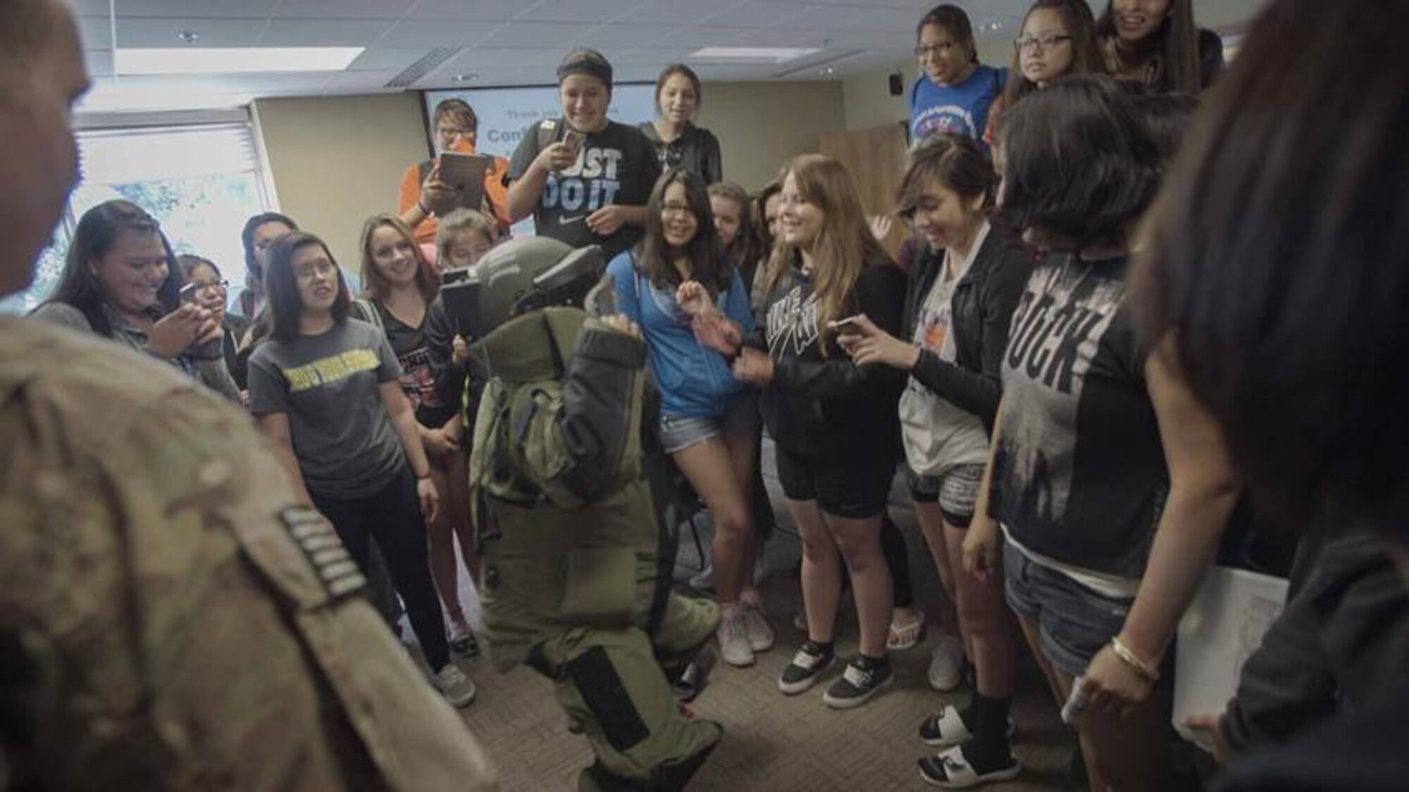 A student from the South Dakota GEARUP summer program wears an explosive ordinance disposal bomb suit at a Native American Outreach career day event at the South Dakota School of Mines and Technology in Rapid City, S.D., July 7, 2015. During the event, students learned about the 28th Civil Engineer Squadron EOD flight, airfield operations, 28th CES structures shop and received a briefing on the 28th Bomb Wing mission from Col. Ty Neuman, 28th BW vice commander. (Courtesy photo/Released)