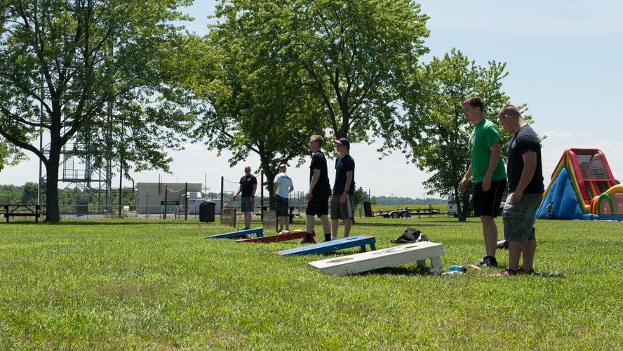 Airmen from the 436th Airlift Wing play cornhole during the 436th AW’s Wingman Day picnic July 10, 2015, at Eagle’s Nest Park on Dover Air Force Base, Del. The Wingman Day picnic is an annual event that takes place each summer. (U.S. Air Force photo/Airman 1st Class Zachary Cacicia)