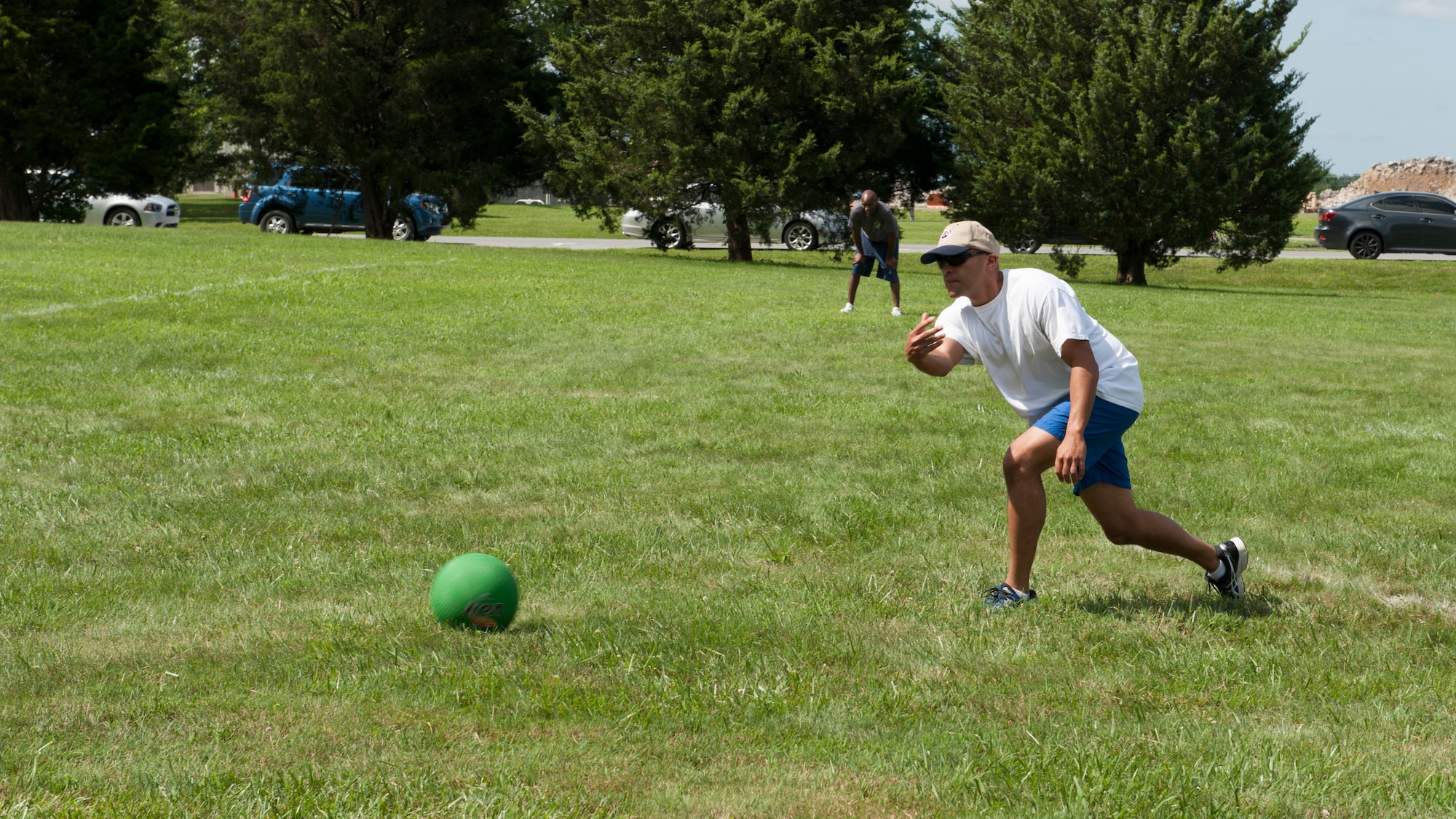 Master Sgt. Arcenio Santiago, 436th Operations Support Squadron training manager, pitches a kickball during a game at the 436th Airlift Wing’s Wingman Day picnic July 10, 2015, at Eagle’s Nest Park on Dover Air Force Base, Del. A kickball tournament was one of many events that took place during the picnic. (U.S. Air Force photo/Airman 1st Class Zachary Cacicia)