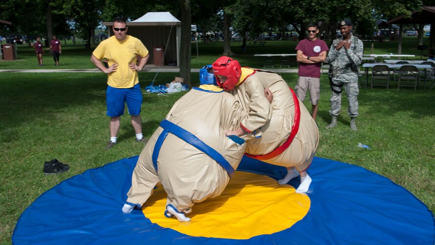 Staff Sgt. Shane Hilts and Senior Airman Germain Duarte, both contract specialists with the 436th Contracting Squadron, sumo wrestle during the 436th Airlift Wing’s Wingman Day picnic July 10, 2015, at Eagle’s Nest Park on Dover Air Force Base, Del. Wingman Day was an all-day event designed to build morale amongst the Eagle Wing’s Airmen. (U.S. Air Force photo/Airman 1st Class Zachary Cacicia)