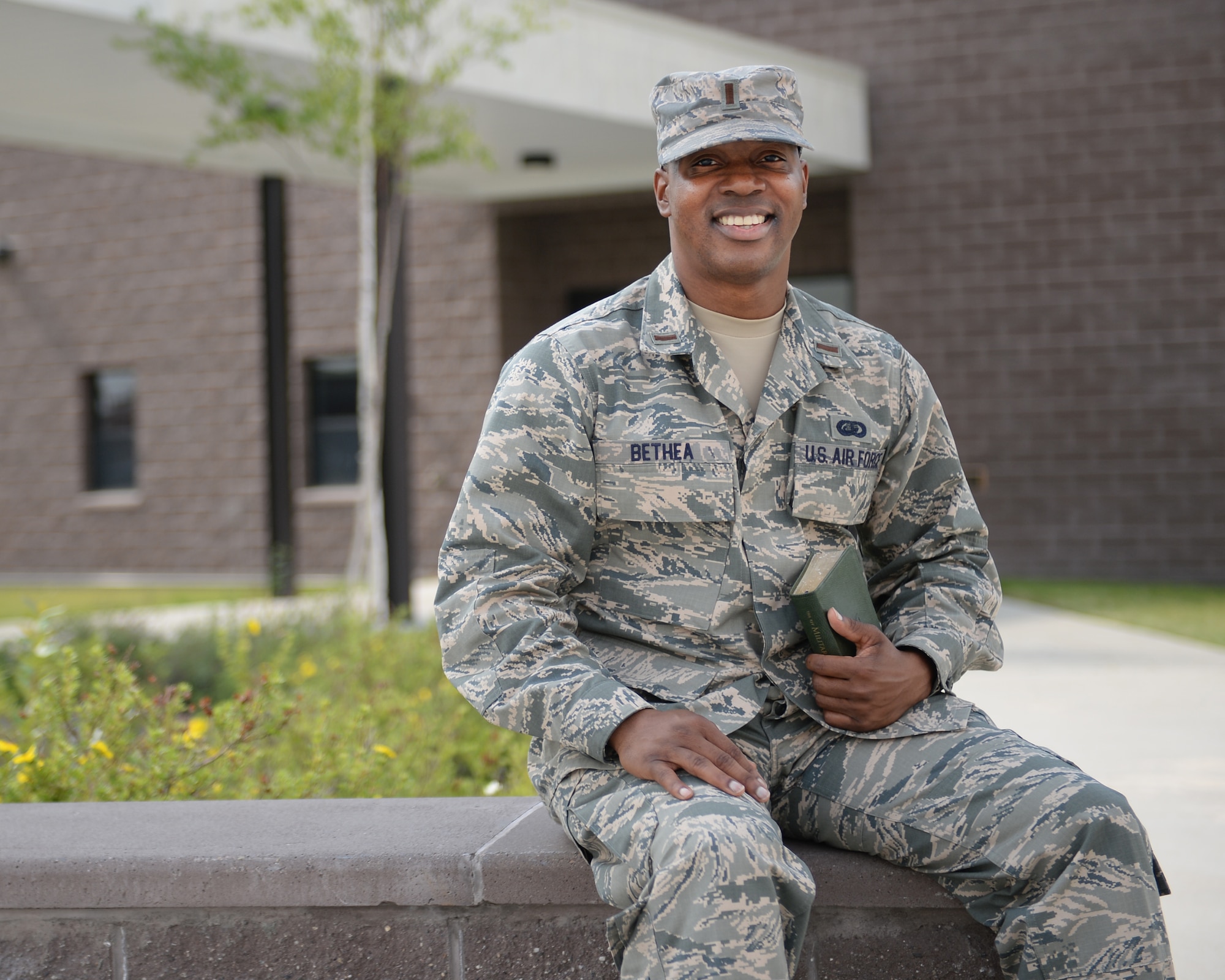 Second Lt. Donnell Bethea, an Air Education and Training Command, 23rd Training Squadron chaplain candidate, stops work for a brief photo July 10, 2015, in front of the Eielson Air Force Base Chapel where he is serving five weeks in an internship. The Chaplain Candidate Program provides seminary students, currently pursuing their graduate theological education, experience in serving as a religious leader within the unique setting of the military. (U.S. Air Force photo by Staff Sgt. Shawn Nickel/Released)