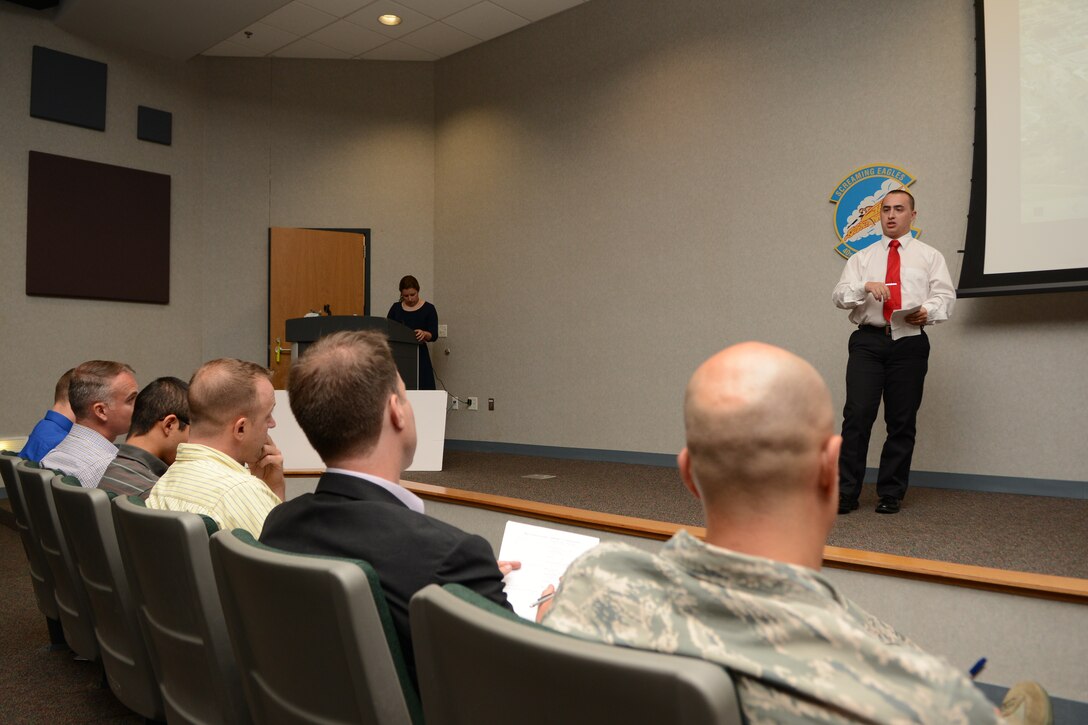 U.S. Air Force Airman 1st Class Johnathan Kropke, 7th Operations Support Squadron ground radar apprentice, speaks during the 2015 Big Country Innovation Challenge June 26, 2015, at Dyess Air Force Base, Texas. As one of the presenters, Kropke suggested transferring paper technical orders to mobile tablets in his section, so all files could be available electronically. He placed third in the challenge and was awarded $1,600 to purchase the tablets. (U.S. Air Force photo by Senior Airman Kedesha Pennant/Released)