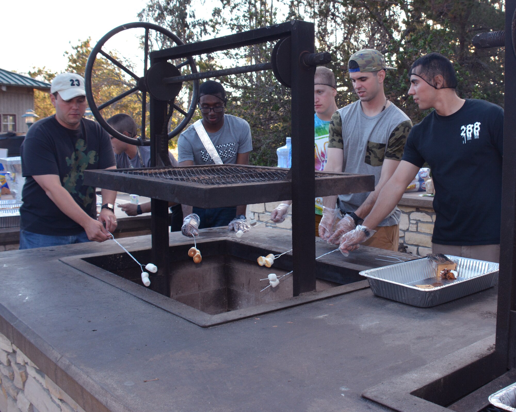 Members of Team V roast marshmallows during the first ever Family Campout event, July 10, 2015, Vandenberg Air Force Base, Calif. The free, family oriented event took place at Cocheo Park and included a barbeque, a movie showing -- and various other activities. (U.S. Air Force photo by Melissa Williams/Released)