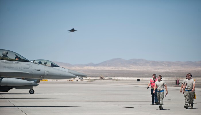 Members of the 20th Aircraft Maintenance Squadron, Shaw Air Force Base, S.C., walk off the flightline after performing an end-of-runway check on three F-16 Fighting Falcons during Red Flag 15-3 at Nellis Air Force Base, Nev., July 13, 2015. Red Flag sorties are typically flown twice a day, a pace that tests both the crews in the air and the maintenance professionals on the ground charged with keeping aircraft in the fight. (U.S. Air Force photo by Staff Sgt. Siuta B. Ika)