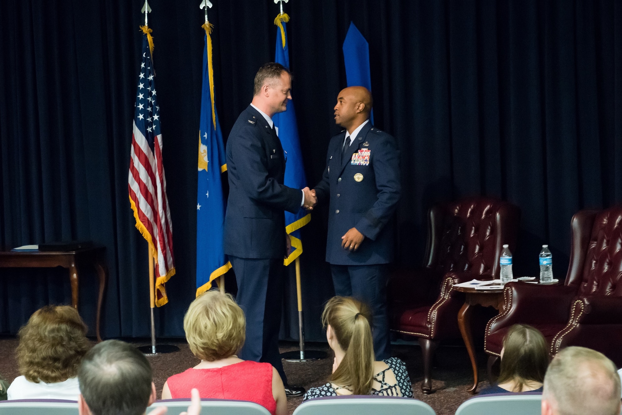 Col. Steven Cabosky, Air Advisor Academy commandant, shakes hands with Brig. Gen. Trent Edwards, 37th Training Wing commander, Joint Base San Antonio-Lackland, Texas, after providing closing comments during the inactivation ceremony for the Air Advisor Academy at Joint Base McGuire-Dix-Lakehurst, N.J., July 10, 2015. The U.S. Air Force Expeditionary Center officially assumed the responsibility of being the Air Force's sole provider of training for general purpose force Air Advisors. (U.S. Air Force photo by Russ Meseroll/Released)