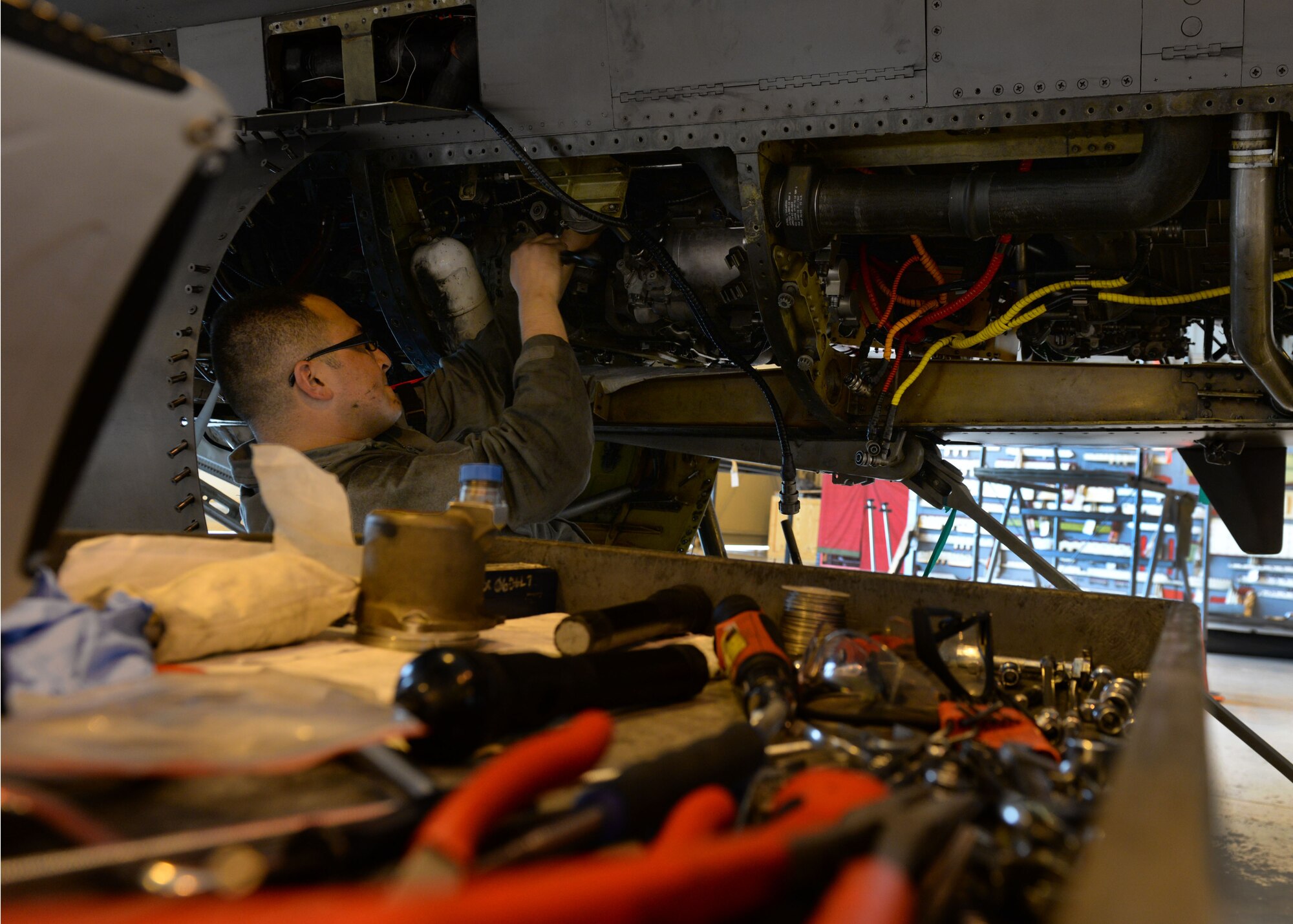 U.S. Air Force Staff Sgt. Angel Gonzalez, 31st Maintenance Squadron aerospace propulsion craftsman, works on the throttle of an F-16 Fighting Falcon engine during a phase inspection, June 16, 2015, at Aviano Air Base, Italy. The engine propulsion shop worked at the phase maintenance shop during the inspection which is required every 400 flying hours. (U.S. Air Force photo by Airman 1st Class Cary Smith/Released) 