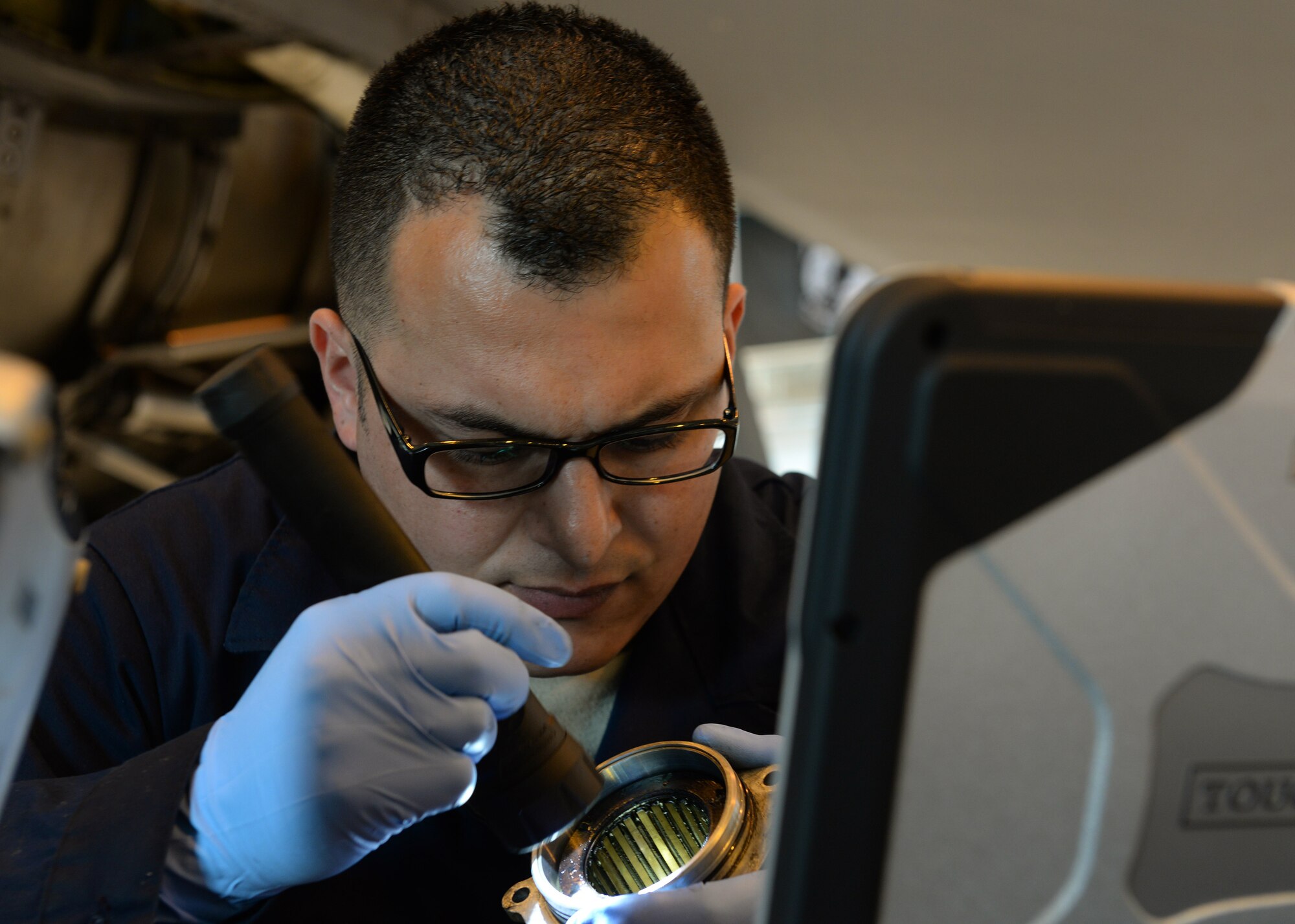 U.S. Air Force Staff Sgt. Angel Gonzalez, 31st Maintenance Squadron aerospace propulsion craftsman, inspects an engine component, June 15, 2015, at Aviano Air Base, Italy. Any engine component inspected must first be removed and certified to meet safety standards before being placed back on the engine. (U.S. Air Force photo by Airman 1st Class Cary Smith/Released)