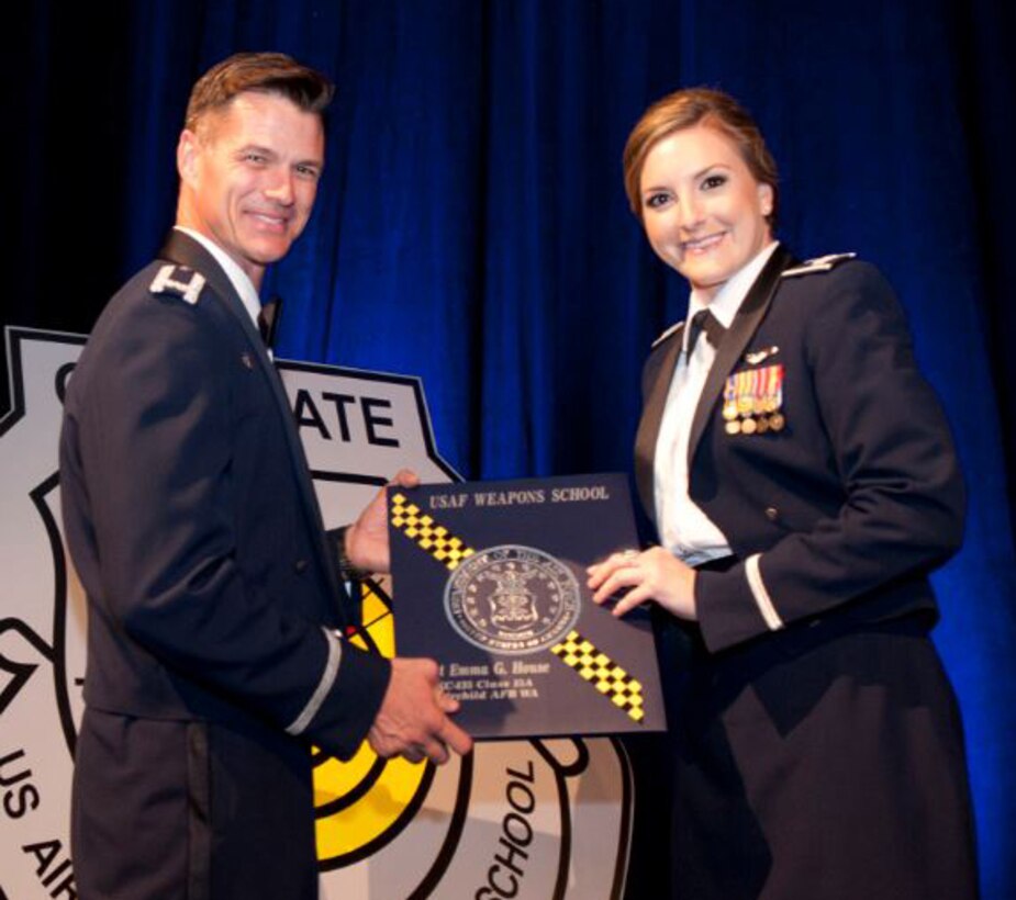 Capt. Emma House, 22nd Air Refueling Wing assistant chief of tactics, receives her Weapons Schools diploma, June 27, at Nellis Air Force Base, Nev. House was the winner of the Tanker Weapons Instructor Course Top Paper Award. (Courtesy photo)