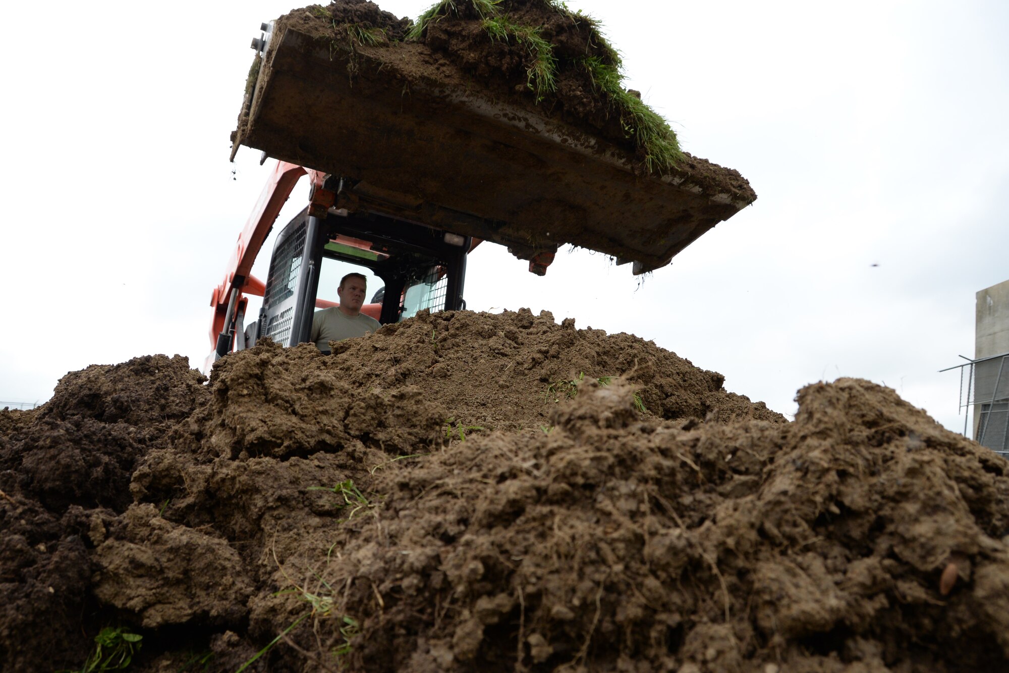 U.S. Air Force Airman with the 181st Intelligence Wing Civil engineering Squadron clears dirt from a construction site at Hulman Field, July 12, 2015. (Air National Guard photo by Airman 1st Class Kevin D. Schulze/Released)