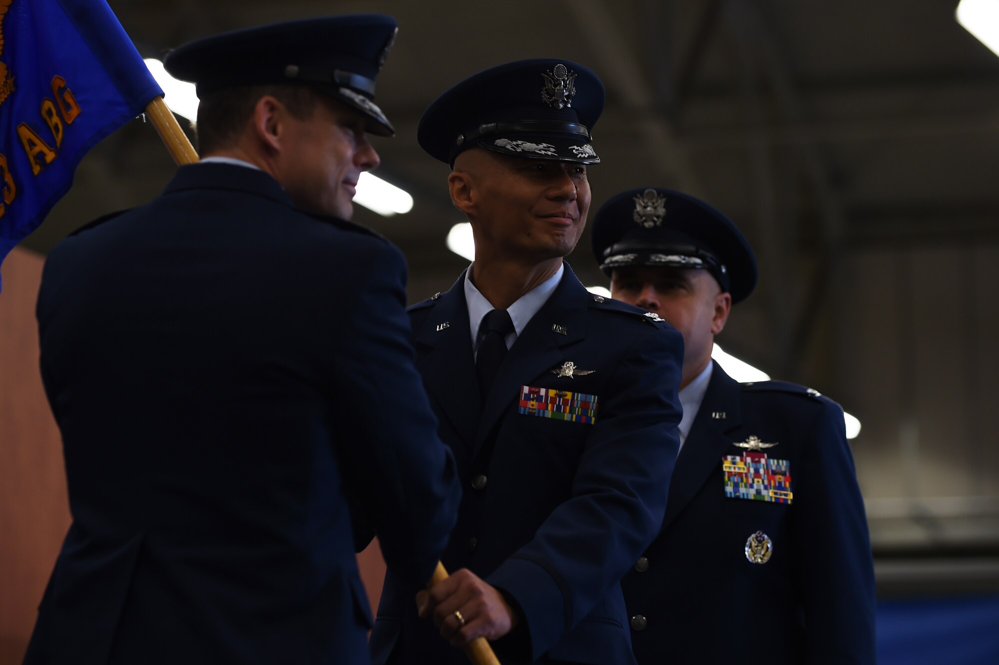 Col. Kevin Cullen, 501st Combat Support Wing commander, left, passes command of the 423rd Air Base Group to Col. Young Yu, during a ceremony at RAF Molesworth, United Kingdom, July 14, 2015. Yu assumed command of the 423rd ABG after service as the director of U.S. Cyber Command Combined Engagement Team. (U.S. Air Force photo by Staff Sgt. Jarad A. Denton/Released)