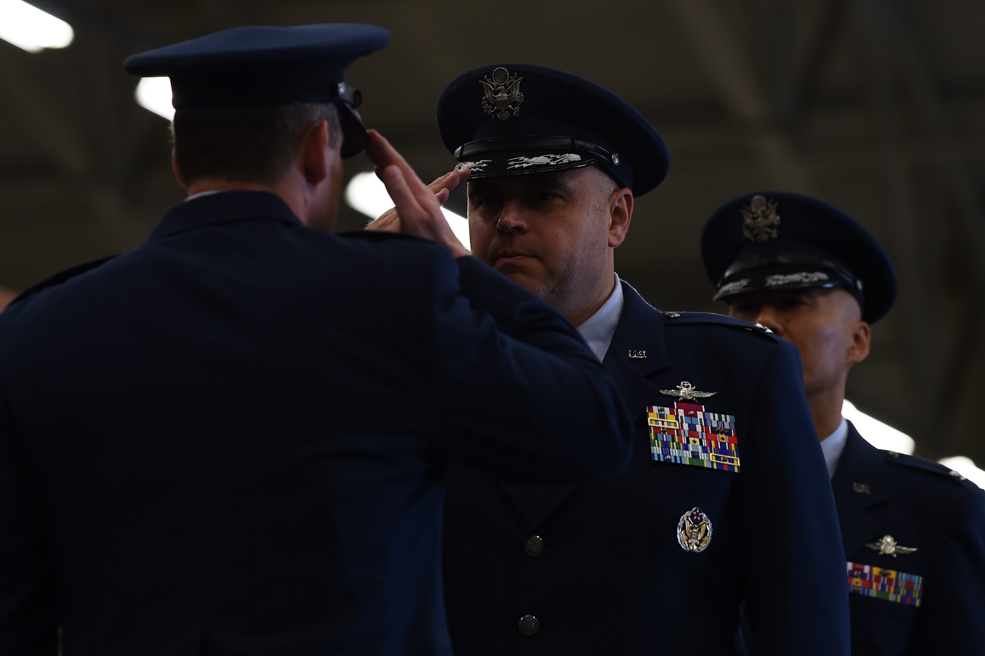 Col. Steven Sweeney, center, renders a salute to Col. Kevin Cullen, 501st Combat Support Wing commander, after relinquishing command of the 423rd Air Base Group during a ceremony at RAF Molesworth, United Kingdom, July 14, 2015. Following the salute, Cullen passed the command to Col. Young Yu. (U.S. Air Force photo by Staff Sgt. Jarad A. Denton/Released)