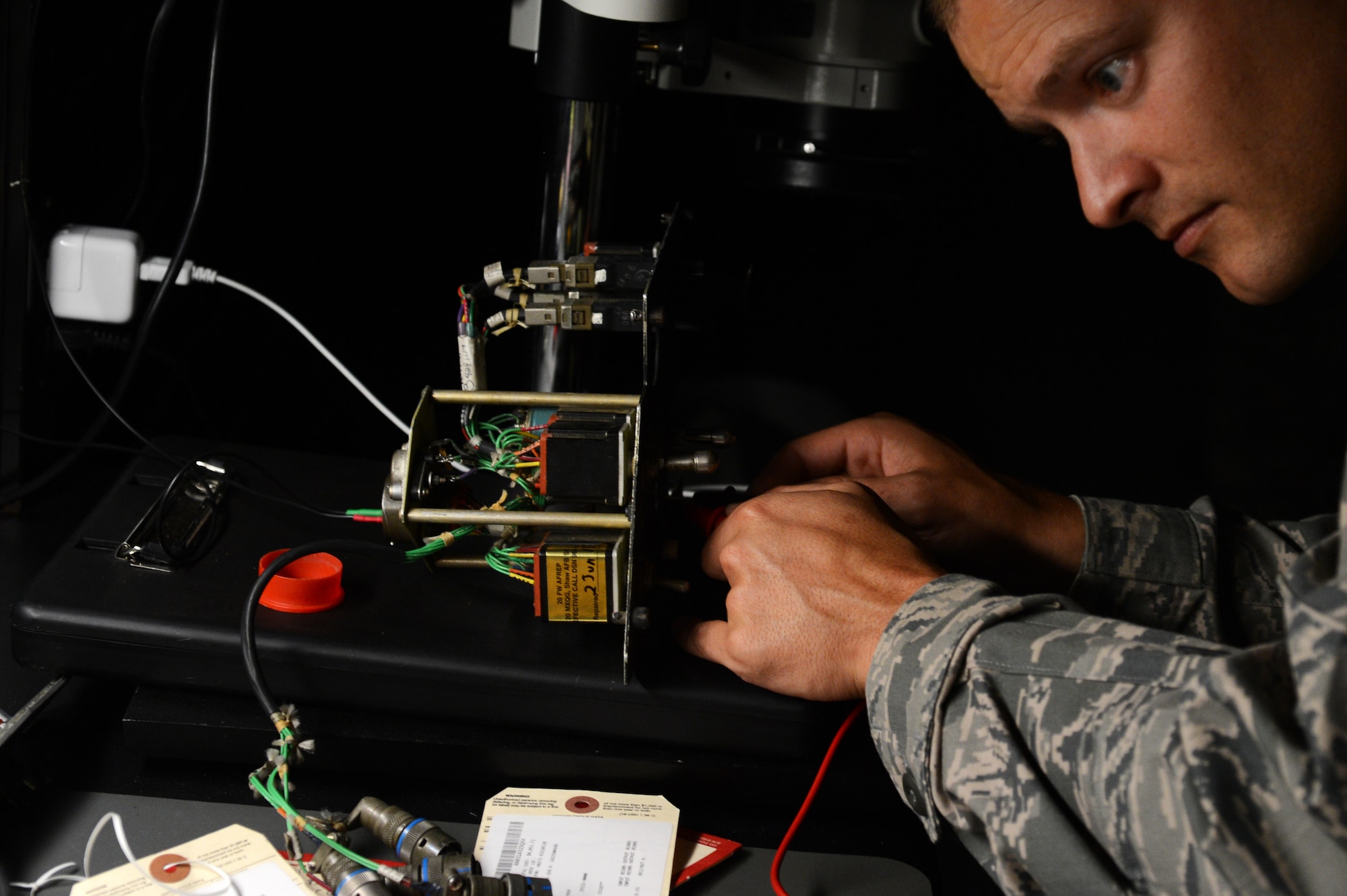 U.S. Air Force Tech. Sgt. Scott Williams, 20th Maintenance Group Air Force Repair Enhancement Program technician, connects a landing gear panel from an F-16CM Fighting Falcon up to power to test the LED lights at Shaw Air Force Base, S.C., June 3, 2015. Williams and two other Airmen have saved the 20th MXG more than $61,000 on landing gear panel repairs alone in fiscal year 2015. (U.S. Air Force photo by Senior Airman Jonathan Bass/Released)