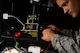 U.S. Air Force Tech. Sgt. Scott Williams, 20th Maintenance Group Air Force Repair Enhancement Program technician, connects a landing gear panel from an F-16CM Fighting Falcon up to power to test the LED lights at Shaw Air Force Base, S.C., June 3, 2015. Williams and two other Airmen have saved the 20th MXG more than $61,000 on landing gear panel repairs alone in fiscal year 2015. (U.S. Air Force photo by Senior Airman Jonathan Bass/Released)