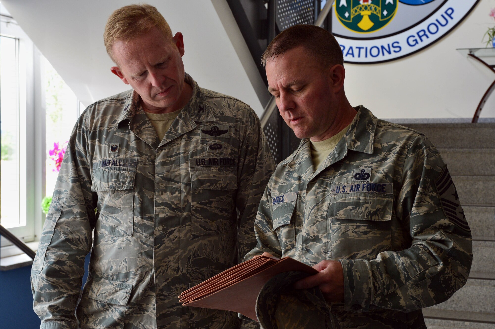 U.S. Air Force Col. Joe McFall, 52nd Fighter Wing commander, and Chief Master Sgt. Brian Gates, 52nd Fighter Wing command chief, discuss their findings during the Dorm of the Quarter competition at Spangdahlem Air Base, Germany, July 8, 2015. The commander and command chief will reveal the final Dorm/Room of the Quarter winners later this month at the Brick House. (U.S. Air Force photo by 2nd Lt Meredith Mulvihill/Released)