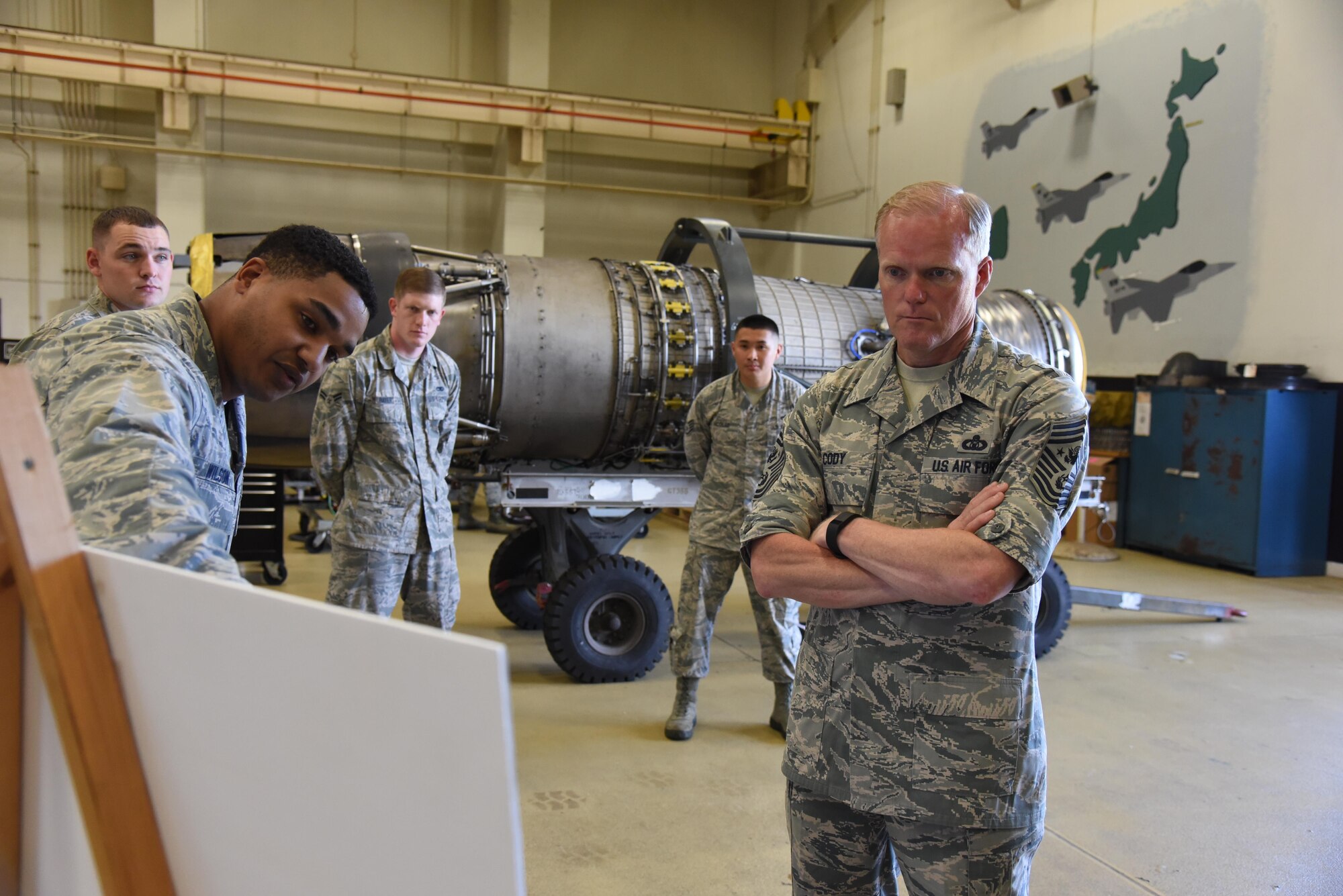 Chief Master Sgt. of the Air Force James Cody is briefed by Airmen from the 35th Maintenance Squadron during a tour of their facilities at Misawa Air Base, Japan, July 14, 2015. During Cody’s visit, he spent time with Airmen from the aerospace ground equipment and propulsion flights, witnessing their job firsthand. (U.S. Air Force photo by Senior Airman Patrick S. Ciccarone/Released)