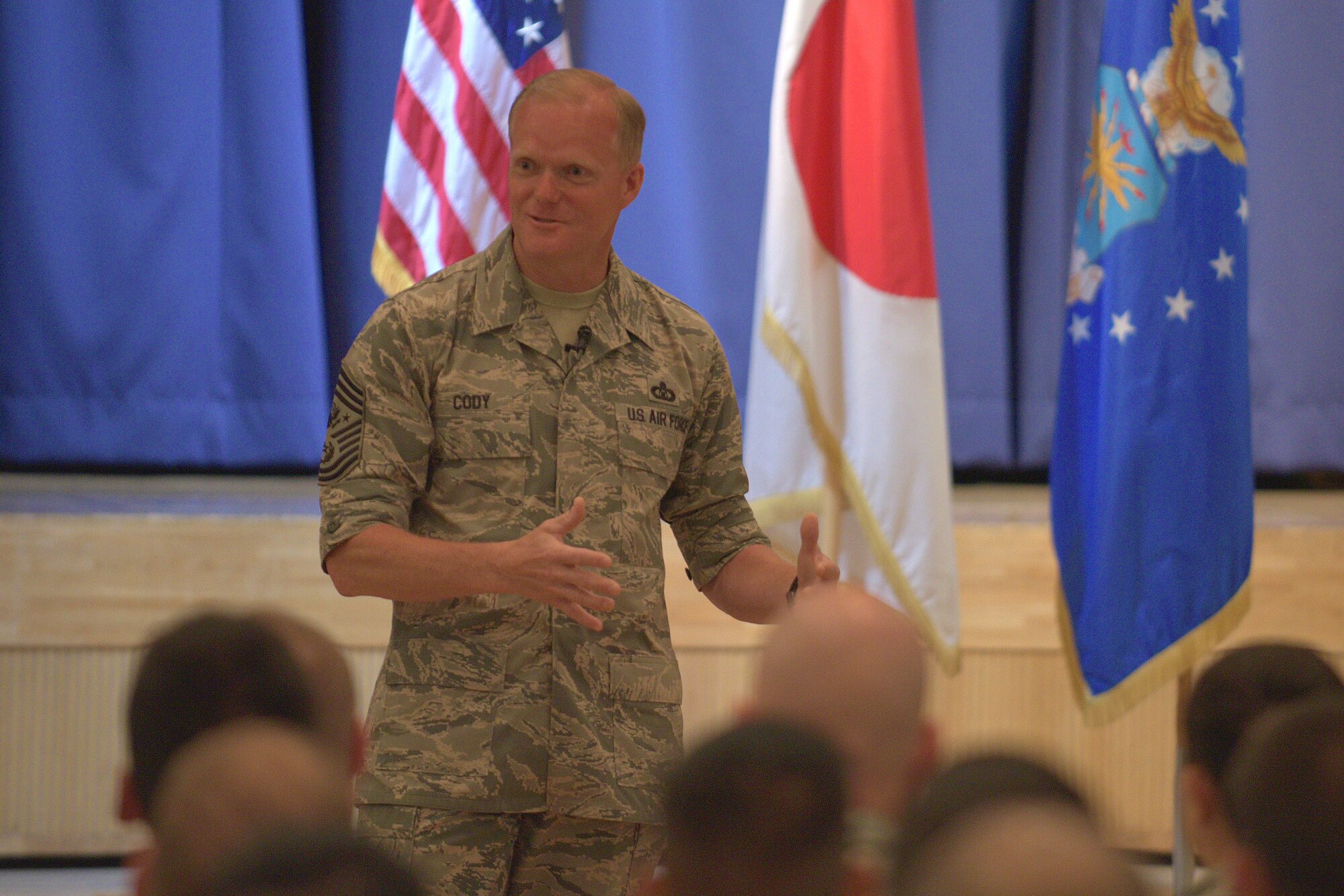 Chief Master Sgt. of the Air Force James Cody speaks to Airmen at Misawa Air Base, Japan, during an all call July 14, 2015. Cody addressed topics like the developmental special duty program, physical fitness standards, retirement, the enlisted evaluation system, basic allowance for housing adjustments and more. (U.S. Air Force photo by Senior Airman Jose L. Hernandez-Domitilo/Released)